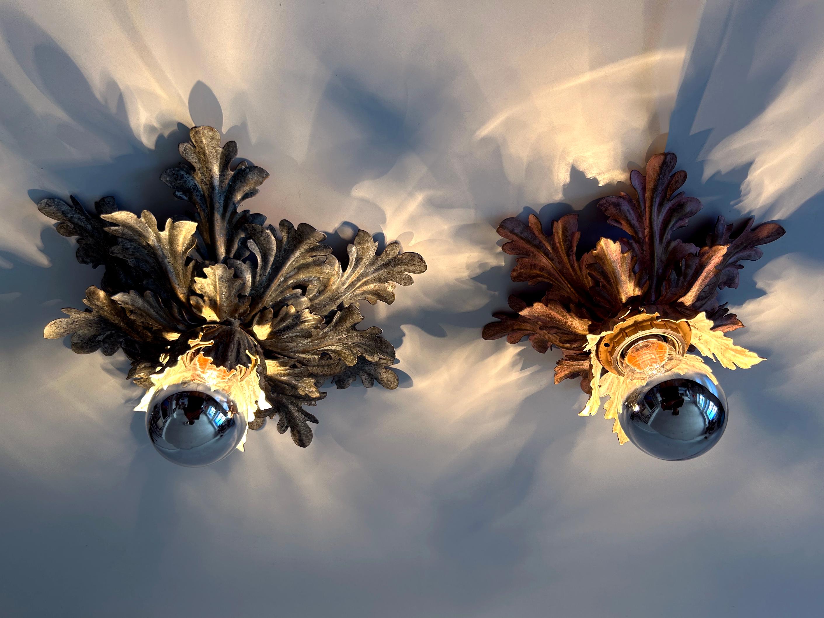Set of two highly decorative Mid-Century Modern floral ceiling fixtures or sconces. Designed & manufactured by W. Müller, Munich, Germany, 1970s. Manufacturers label beneath the one fixture.

Executed in rose and green patinated metal sheet, each