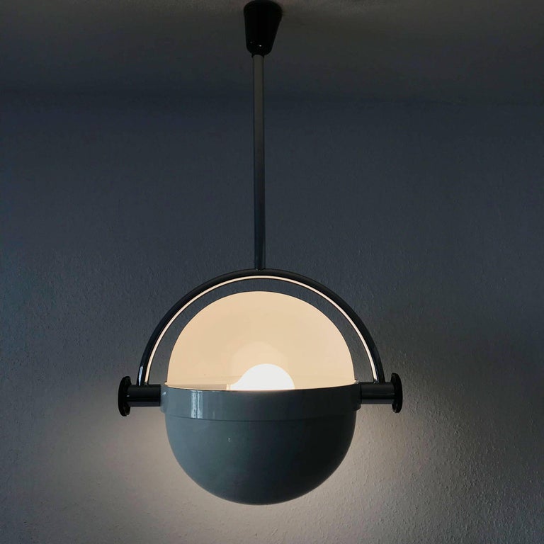 Extremely rare, elegant Mid Century Modern pendant lamp with rotating lampshade. The lamp resembles to the famous 'O-look' by Superstudio. Designed and manufactured in Italy, 1970s. 

Executed metal and steel, the pendant lamp needs 1 x E27 / E26