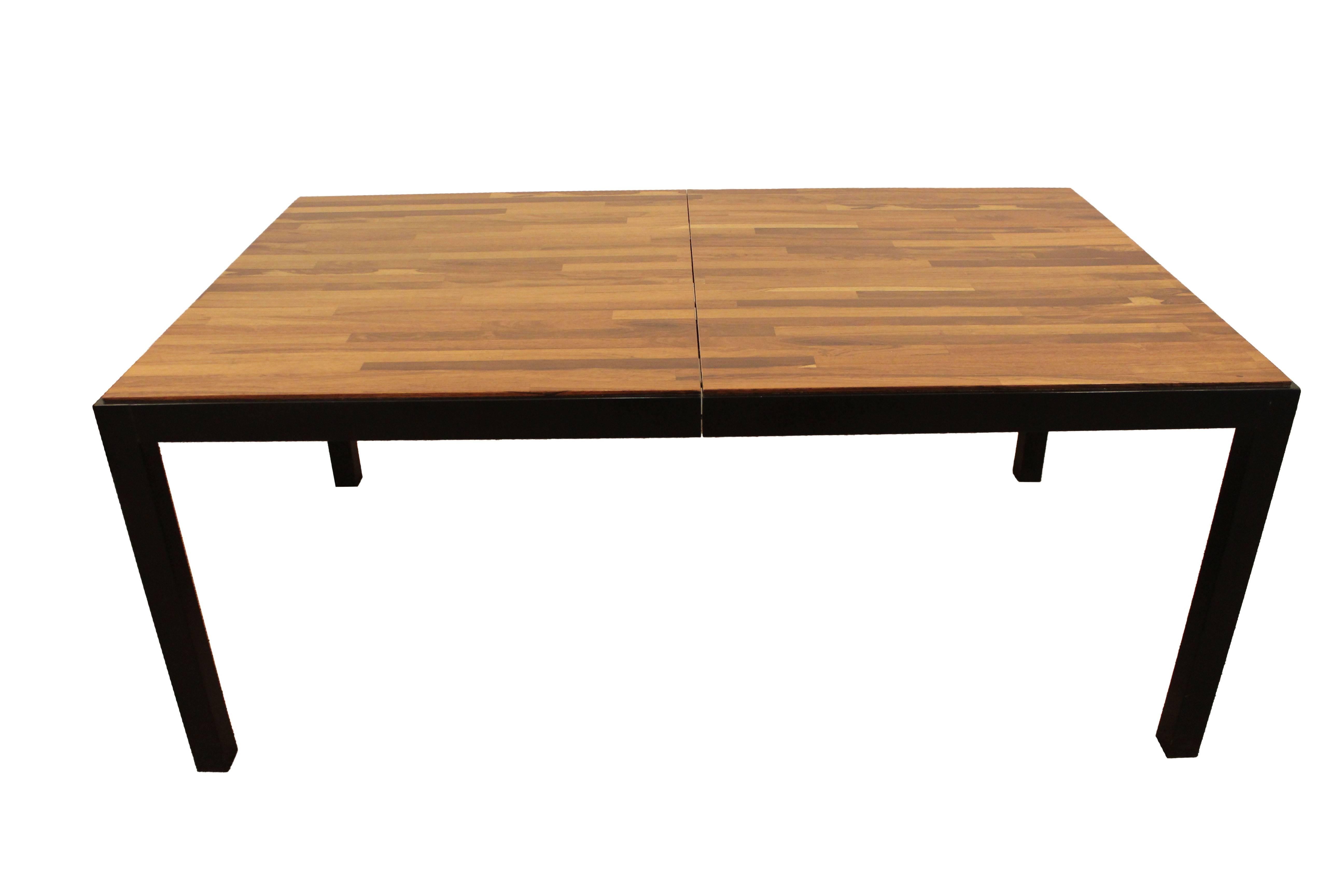 This table was designed by Milo Baughman for Directional. It has a parqueted top with mixed woods and ebonized legs. Includes two extension boards. It was designed by Milo Baughman for Directional.

Dimensions: 
Without extensions 68