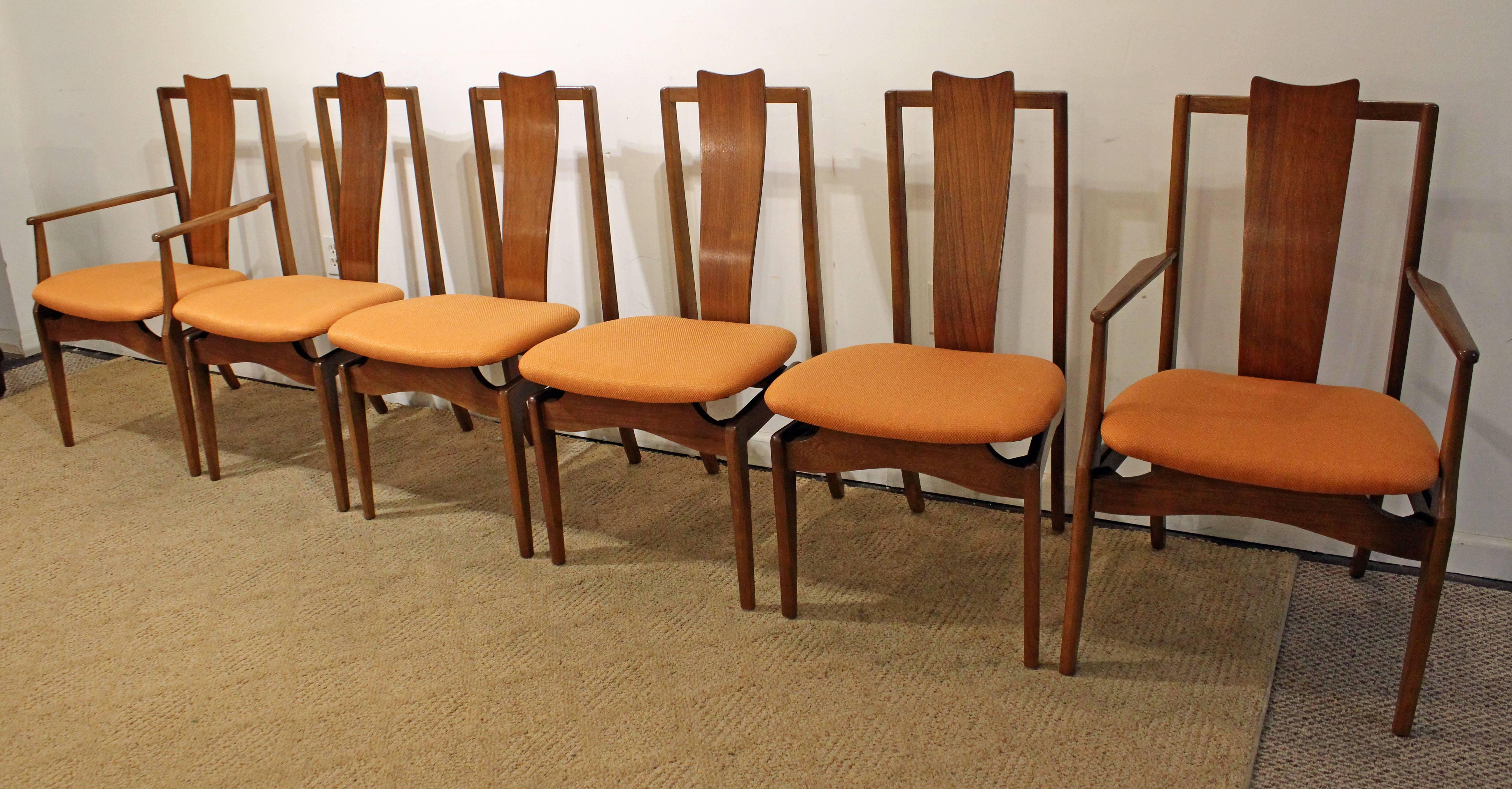 Offered is a set of six walnut dining chairs by Young Mfg Co. Includes two arm chairs and four side chairs. Features sculpted backs and floating seats that have been reupholstered. In very good condition with minor age wear (see pics).

Measures: