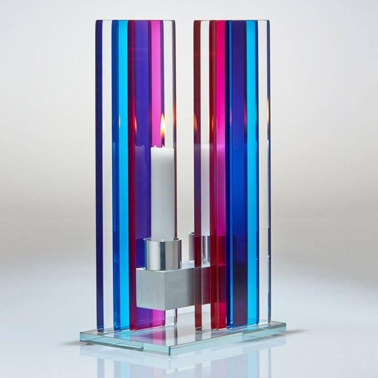 This polished glass, double candleholder from the Unified Light series is designed by world renowned glass artist, Sidney Hutter. With 40 years of experience in the contemporary glass and fine art world, Sidney now creates illuminated designs for