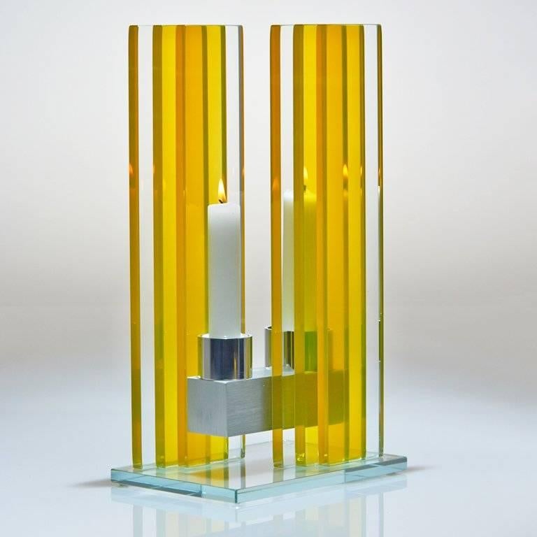 This polished glass, double candleholder in the Unified Light series is designed by world renowned glass artist, Sidney Hutter. With 40 years of experience in the contemporary glass and fine art world, Sidney now creates illuminated designs for the