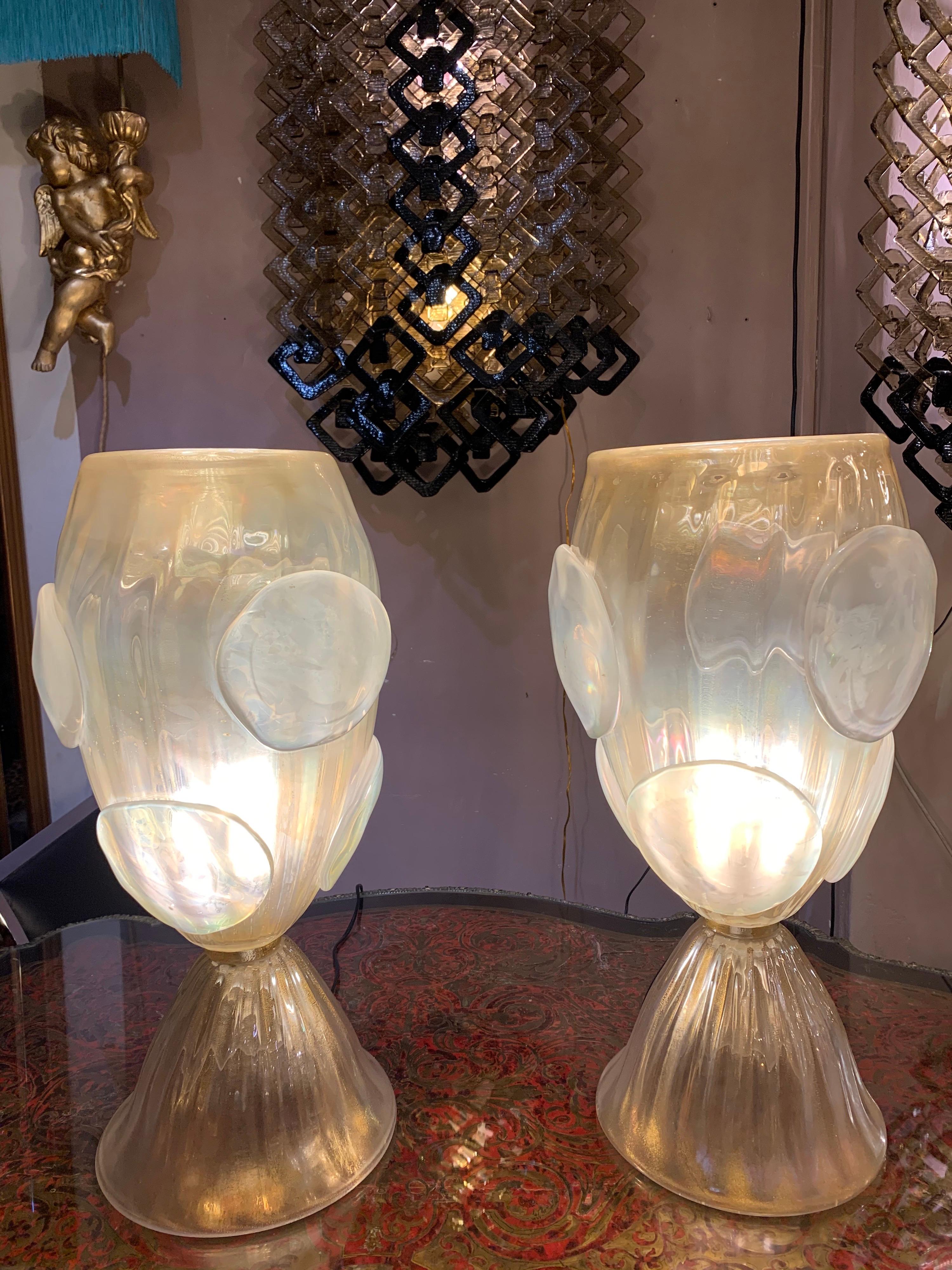 Pair of hand blown gold flecks Murano glass table lamps with iridescent effect.
The Murano glass is infused with gold powder.
The cup of the lamp consists of hand blown Murano glass round applications
One bulb each lamp.