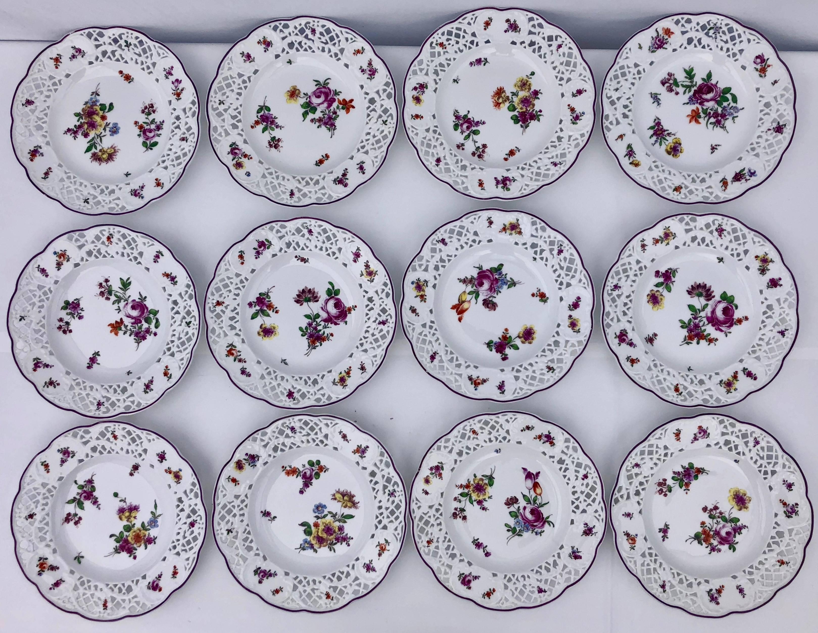 These absolutely stunning Meissen plates have reticulated borders, a band trim and floral decorations. This elegant set of 24 plates, each having a different complimentary pattern, are beautiful in their detailed design and the colors on the white