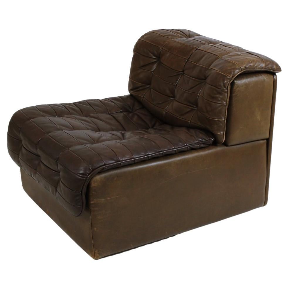 Vintage patchwork brown leather armless loveseat, manufactured by De Sede of Switzerland in the 1970s. The pieces feature a modular design and can be used together as a small couch and to add on to a sofa or separated as individual chair
Vintage