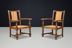 Pair of French Oak and Rush Armchairs in the Manner of Charles Dudouyt, France