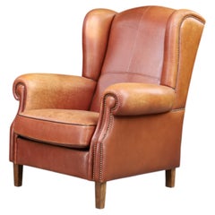 Poltrona lounge con schienale ad ali in pelle color cognac patinata, Paesi Bassi, anni ’60