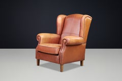 Poltrona lounge con schienale ad ali in pelle color cognac patinata, Paesi Bassi, anni ’60