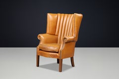 Exceptional Sculptural Barrel-Back Wing Chair in Patinated Cognac Leather 1870