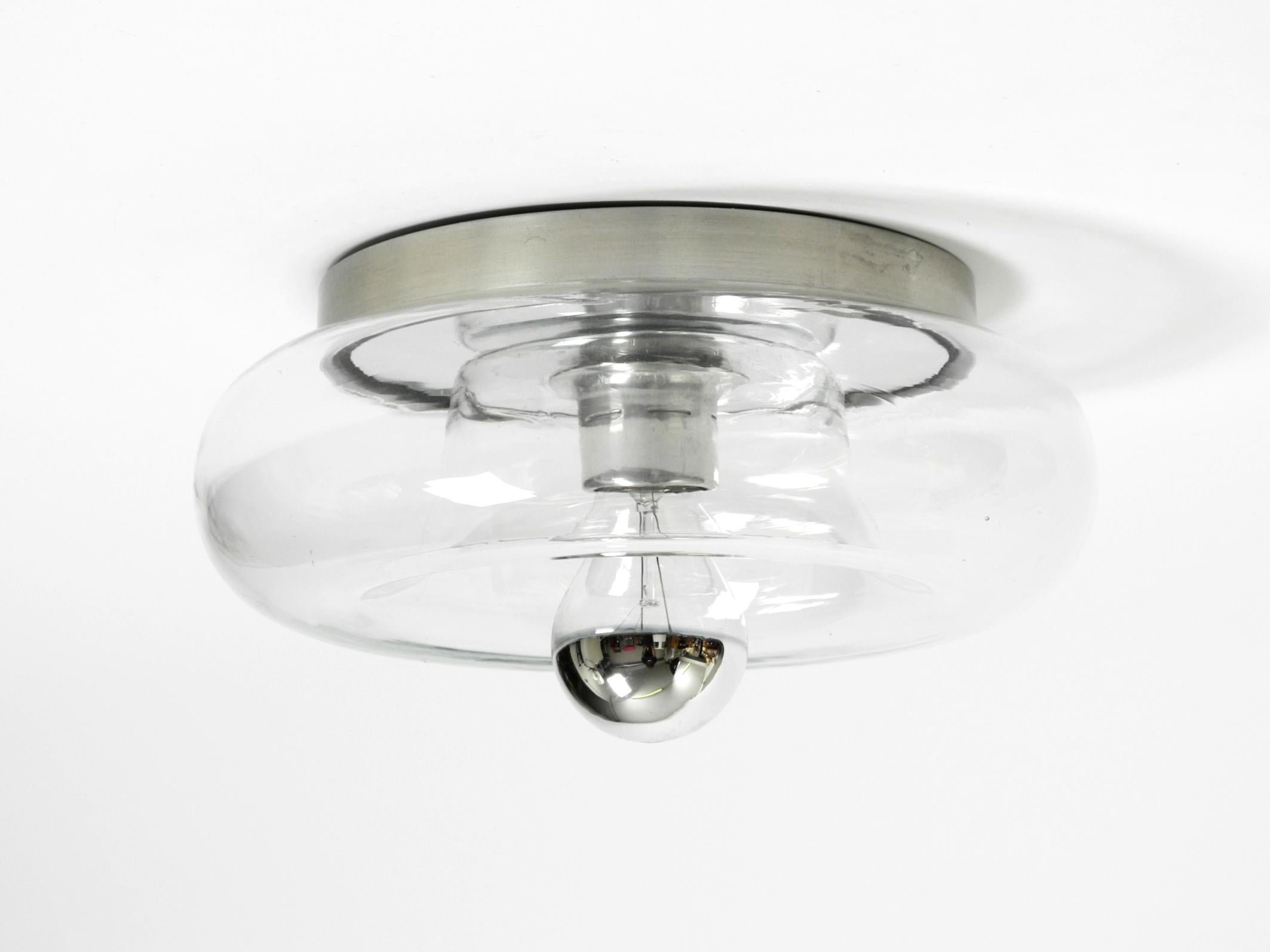Metal Original 70s round donut wall or ceiling lamp made of transparent glass by Doria For Sale