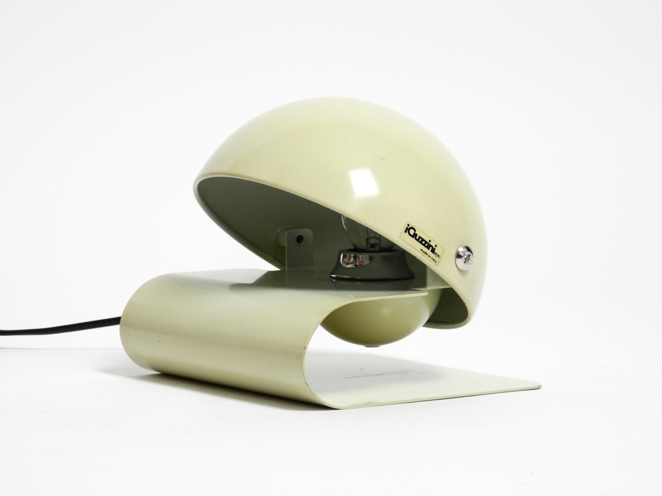 A stunning metal table lamp by Giuseppe Cormio for iGuzzini, the Bugia model.
Exceptional Space Age design from the 1970s. Made in Italy. With original label.
The frame is made entirely of metal, painted beige.
The shade is steplessly