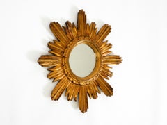 Italian Mid Century Sunburst gold-plated wall mirror made of wood and resin