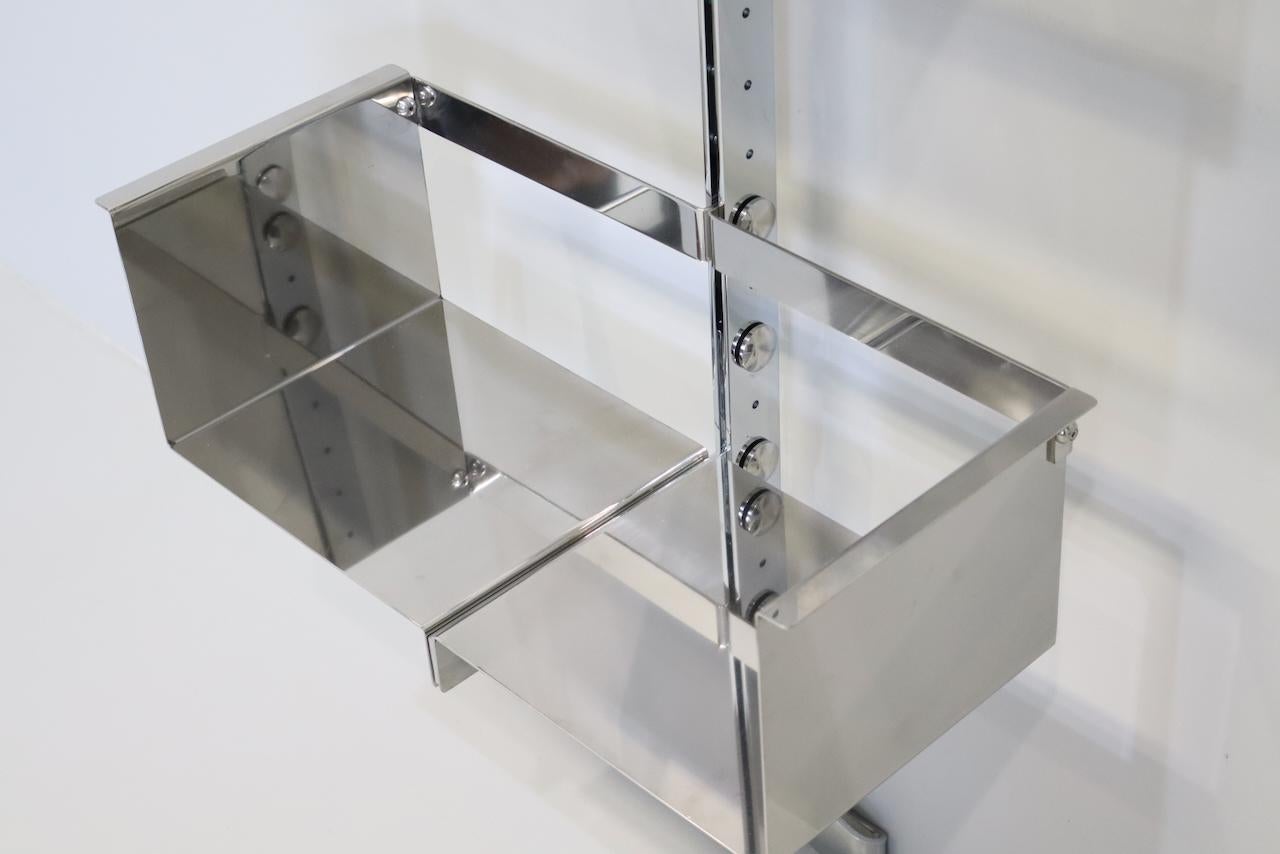 Pair of modular wall-mounted shelving system designed by Vittorio Introini, produced by Saporiti, Italy, circa 1969.  Stainless steel, very good condition. Shelves can be used individually or combined together in many different ways 3 shelves for