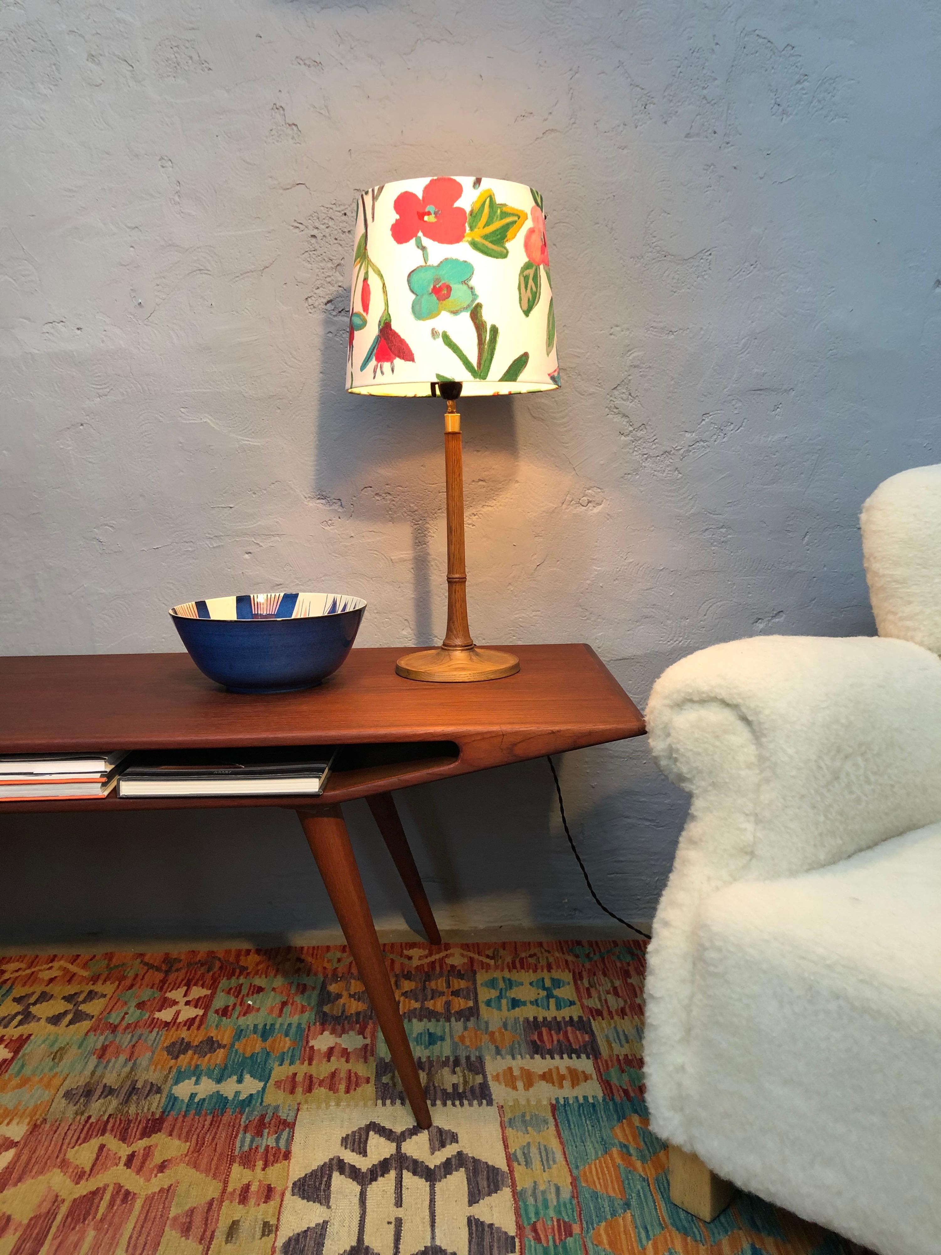 Iconic Danish Esben Klint table lamp model 301/27 in solid teak and designed for Le Klint in the 1940s.
Turned base and stem. 
Original Bakelite bulb holder and rewired.
Stunning handmade lampshade from ArtbyMaj in the manner of Joseph Frank.
Can be