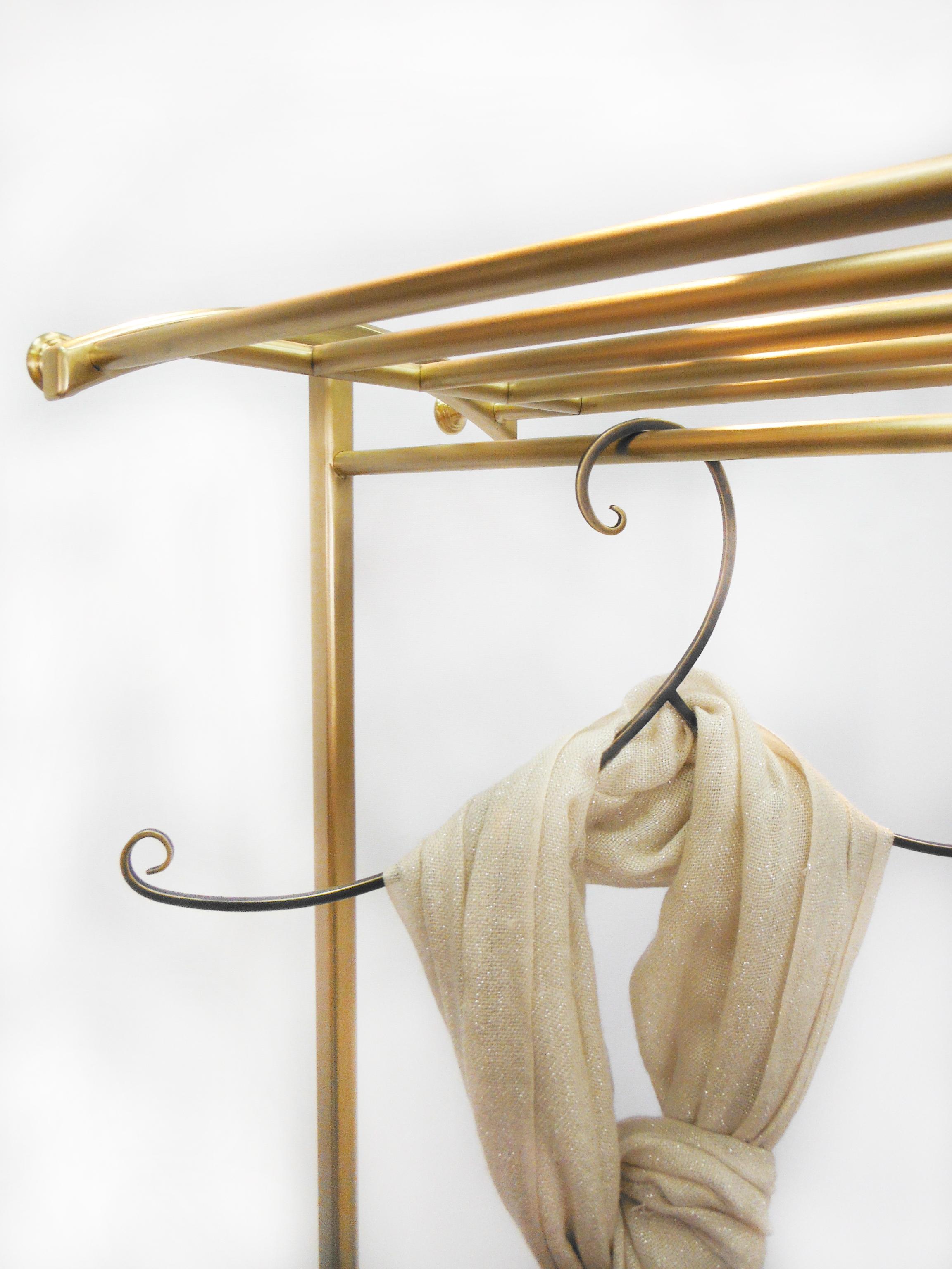 Beautifully handcrafted by artisans from solid architectural bronze. Removable wheels add flexibility and functionality. Aesthetically proportional curvature adds elegance to the piece. This clothing rack is perfect for coats and can hold shoes as