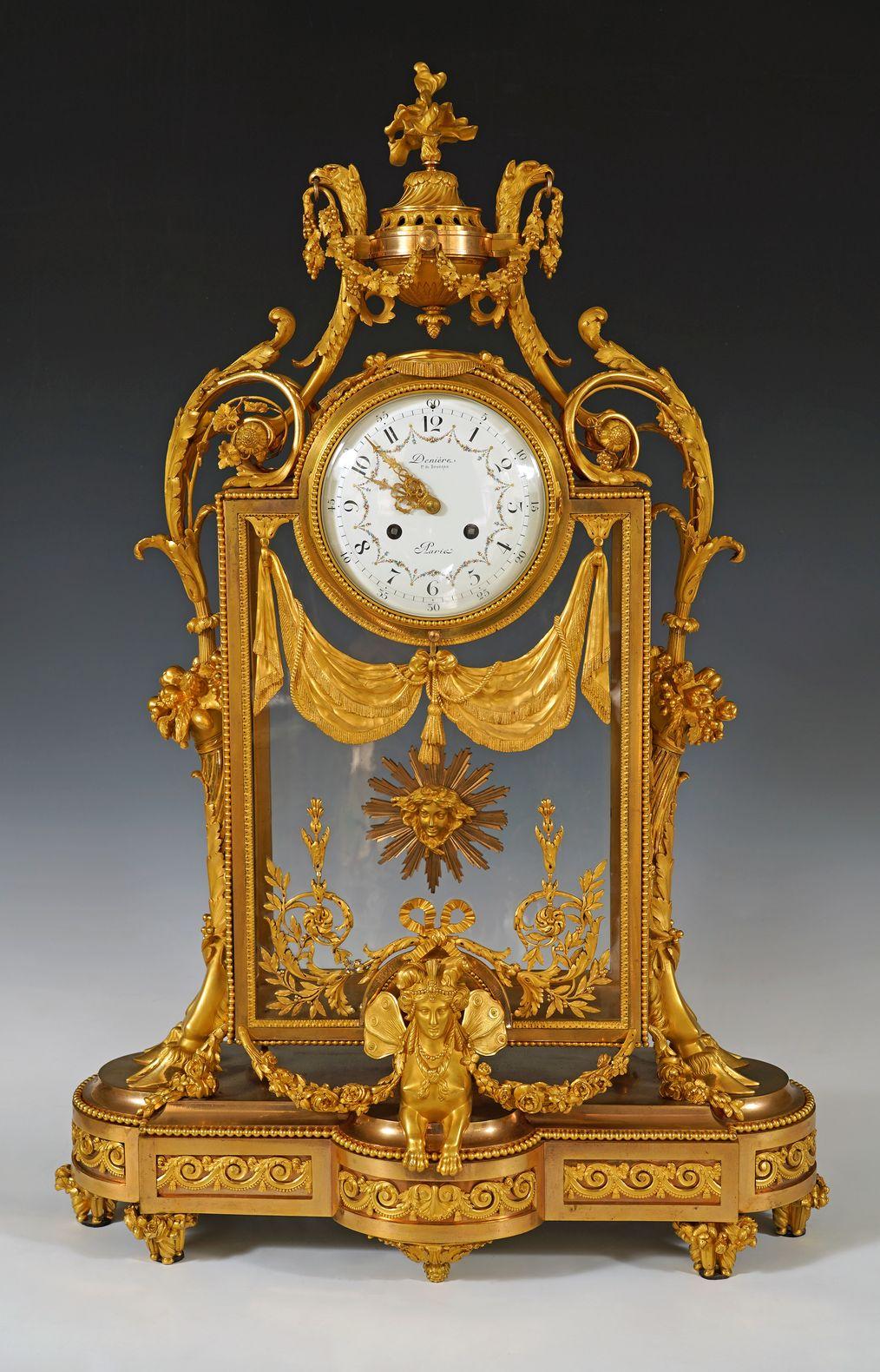 Large and rare Louis XVI style cage clock in chiseled and gilded bronze, rectangular in shape, highlighted with friezes of water leaves and pearls, with glass panels decorated with tasseled draperies and ribboned foliage. The circular white enamel