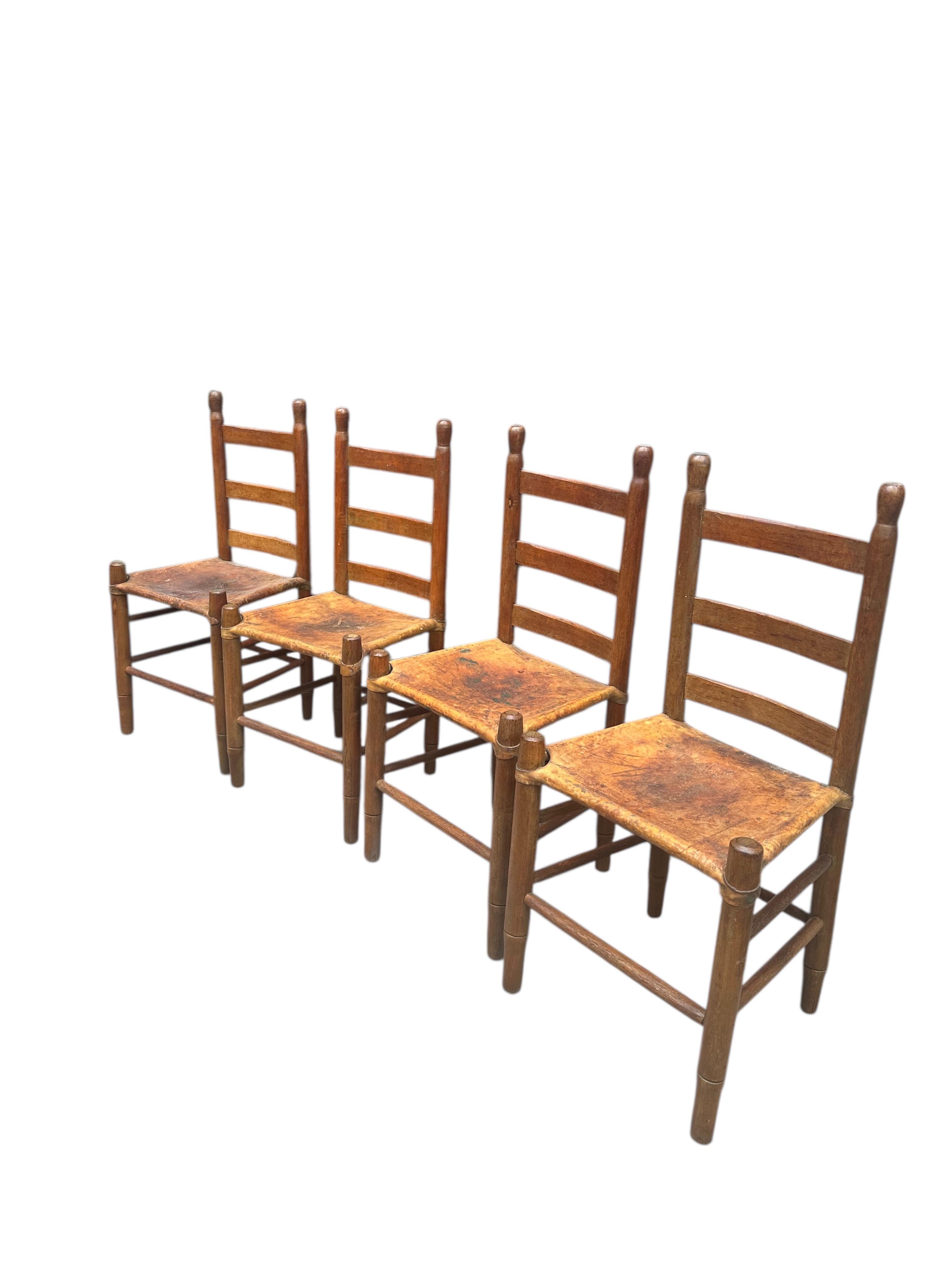 Rustic Set of Four Early 20th Century American Ladder-Back Wood and Deer Hide Chairs. For Sale