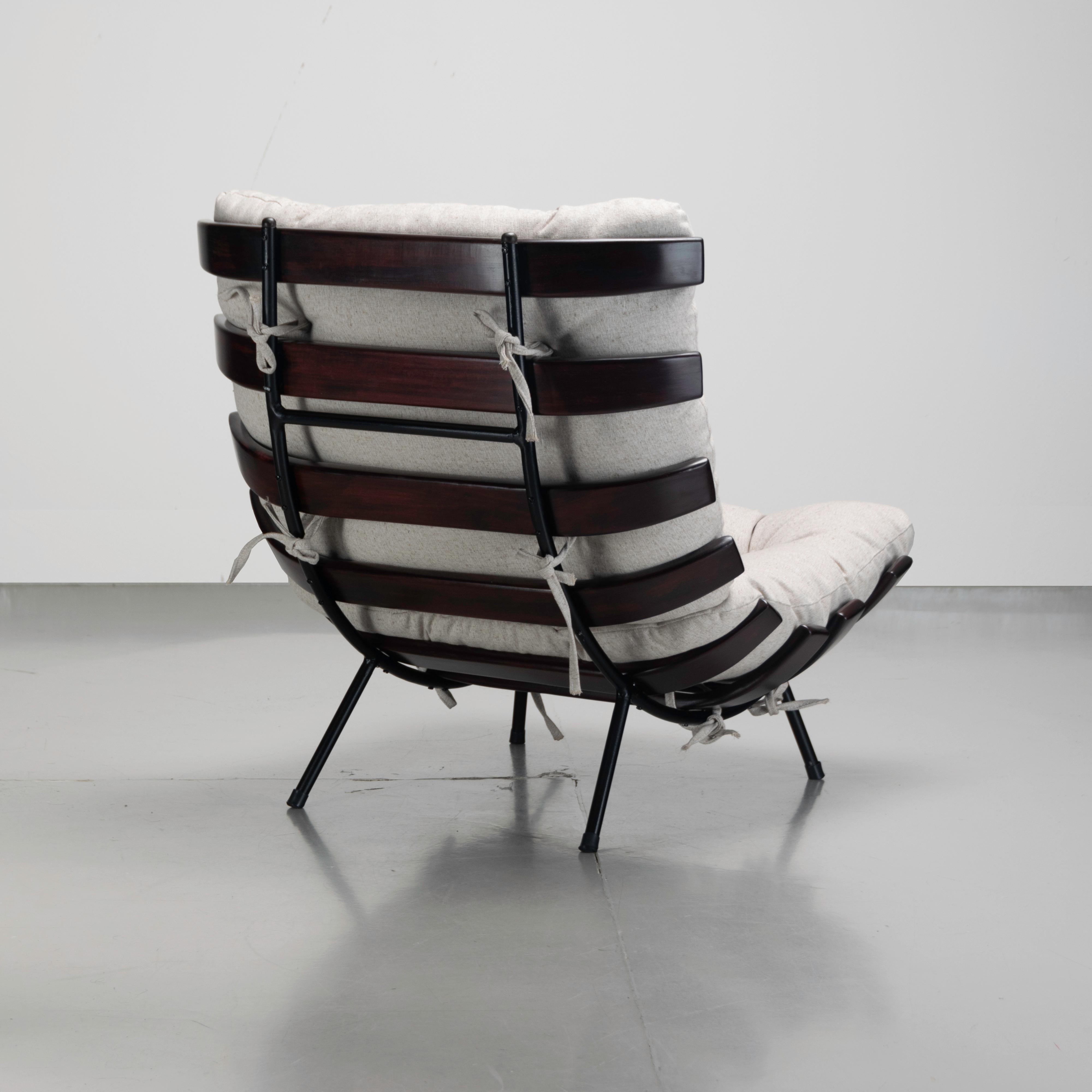 Rib chair (also called Costela chair) designed by Martin Eisler and Carlo Hauner in Brazilian hardwood and metal. The chair has been recently reupholstered in off-white linen.

The Costela chair was designed by Martin Eisler in 1953 and manufactured