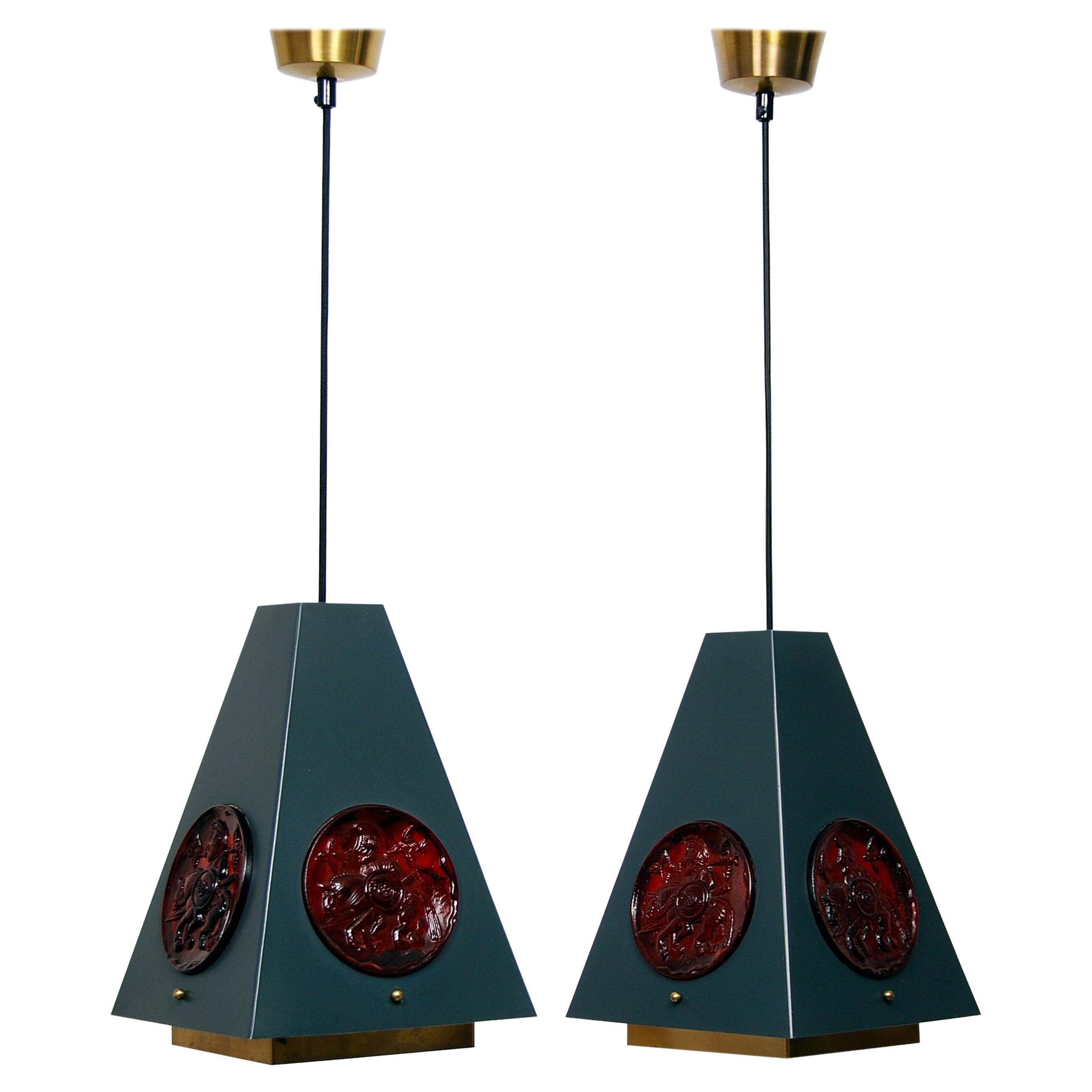 High quality ceiling lights in brass, lacquered metal and glass. Simple cubist shapes and superb color matching give these lamps something extra. The lamp parts are made by Einar Bäckström and the glass parts is designed by Erik Höglund. The brass