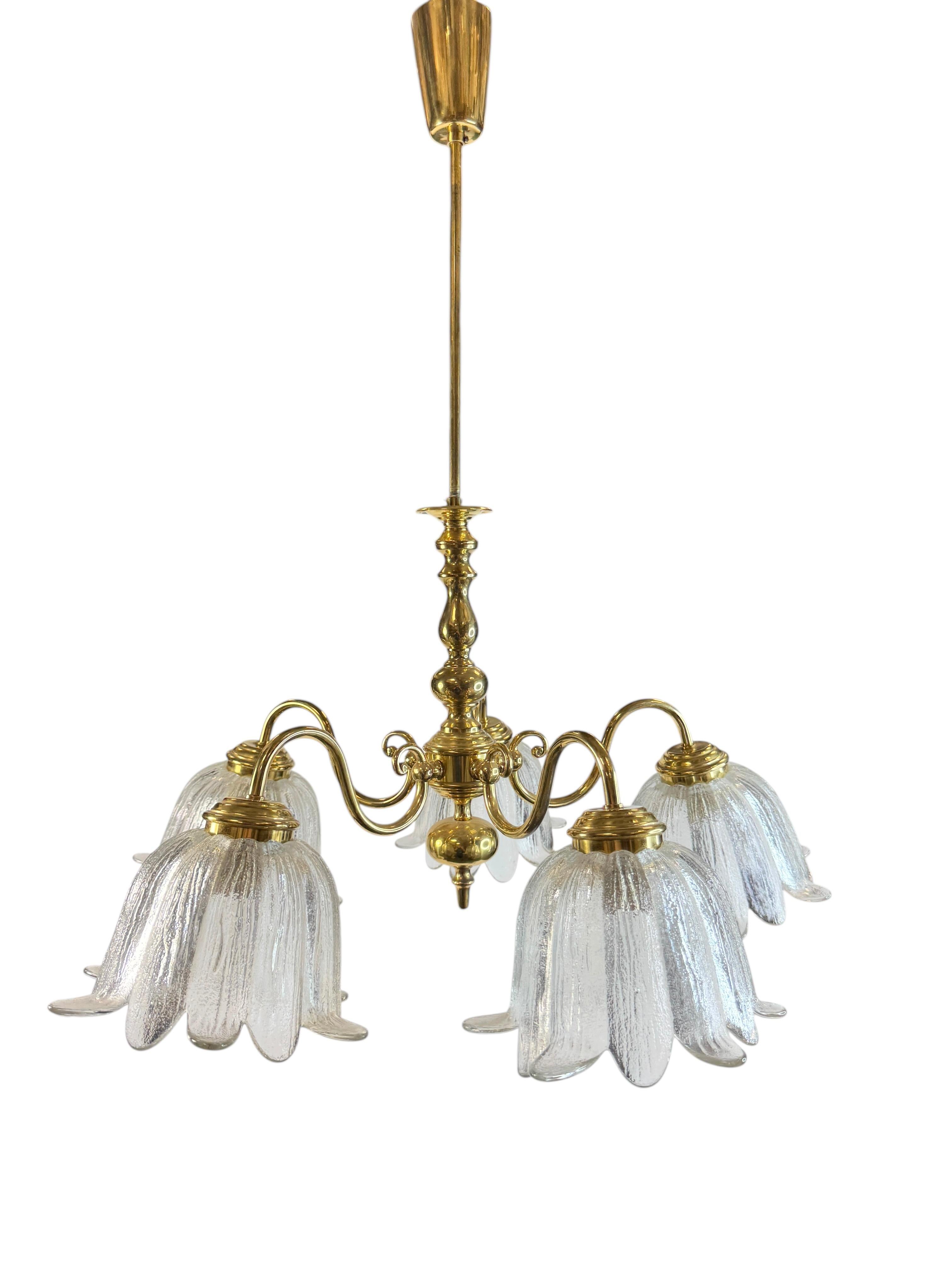 Add a touch of opulence to your home with this charming chandelier! It is in brass metal, with calyx pattern glass lampshades, to enhance any chic or eclectic home. We'd love to see it hanging in a bedroom or dinning room as a charming accessory to