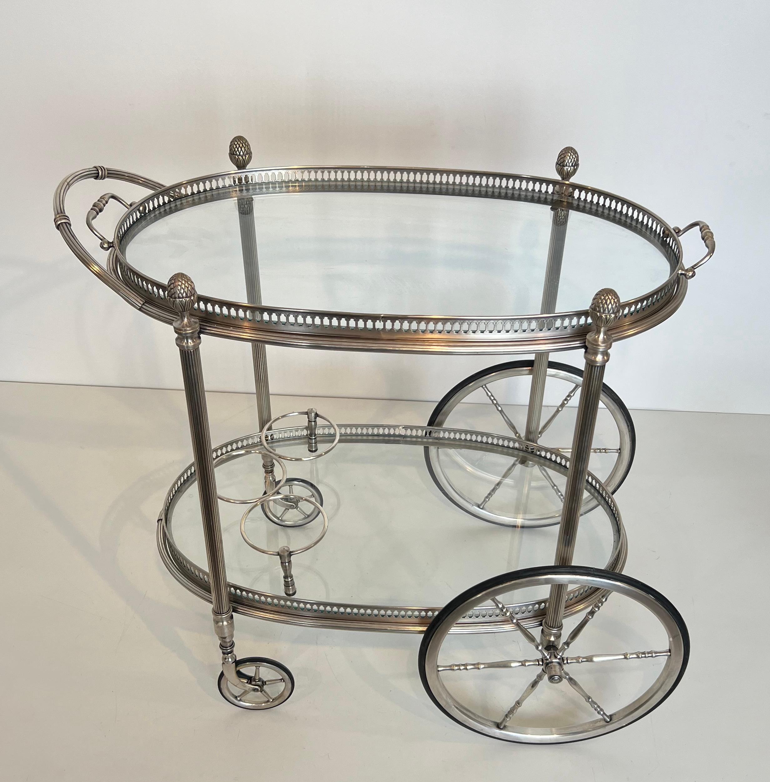 This very nice and elegant neoclassical Style Oval Bar Cart is made of silvered brass with removable trays. This is a French work by Maison Bagués. Circa 1940