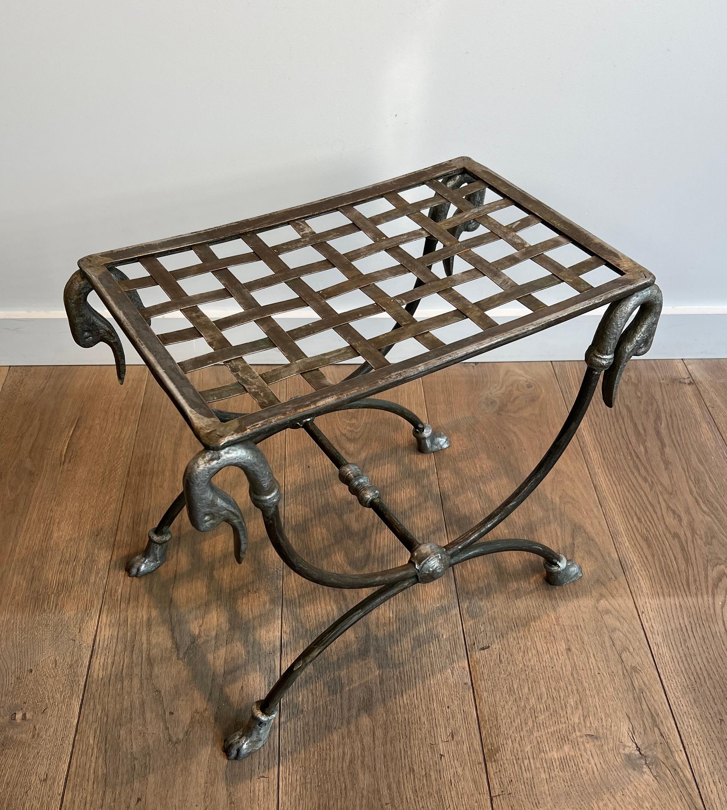 This very nice and elegant neoclassical style curule stool is made of steel and decorated with duck heads and feet. This is a French work attributed to Maison Jansen. Circa 1940