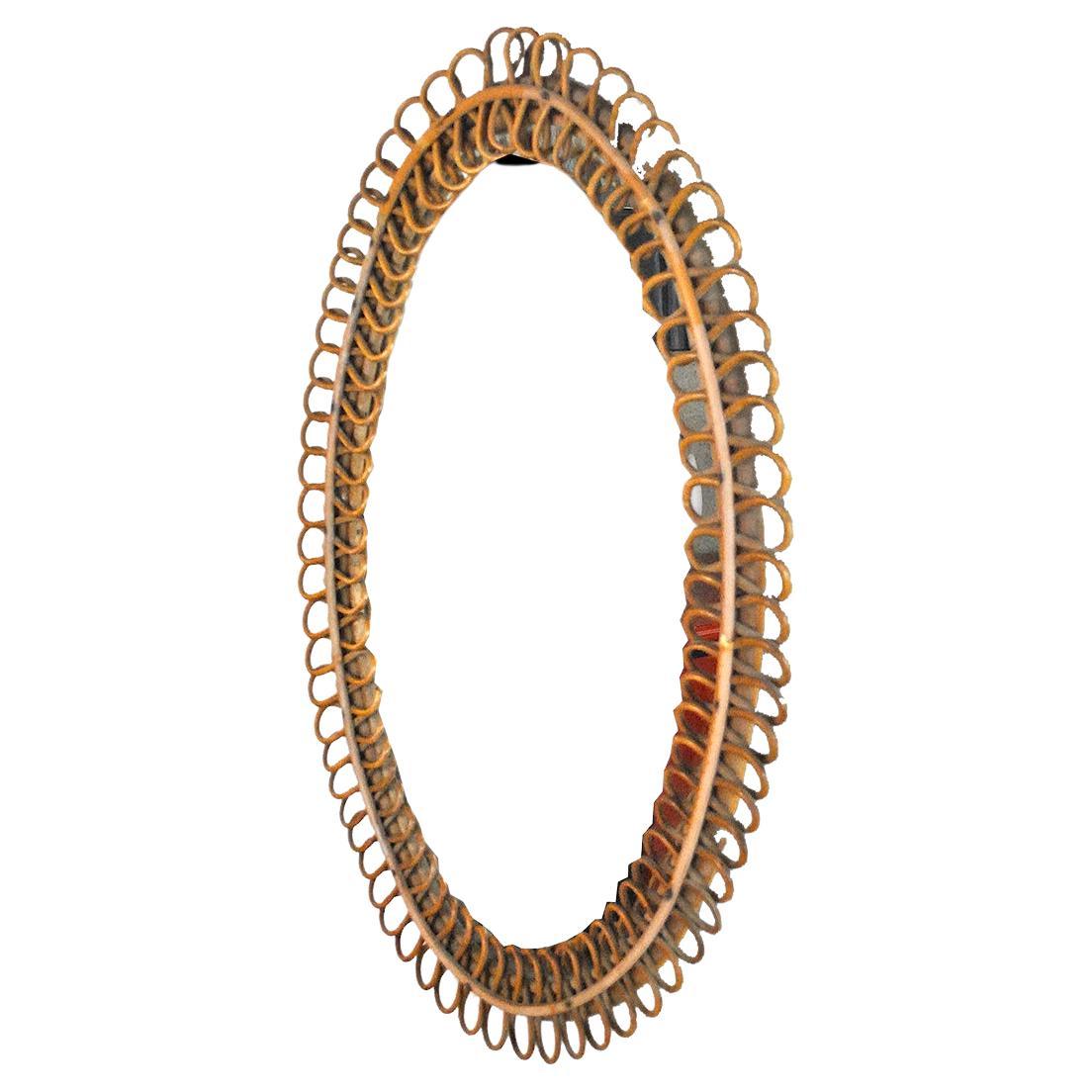 Mid-century wicker and bamboo oval mirror in the style of Franco Albini in very good condition.