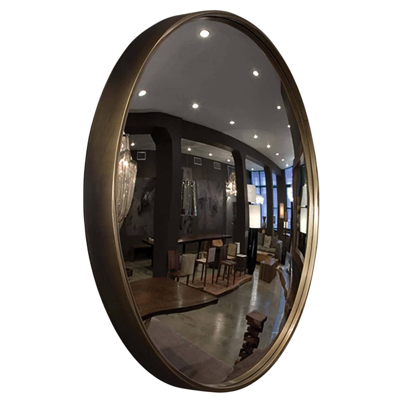 The Bronze Convex Mirror consists of a solid bronze frame covering the convex mirror lens. The bronze color bodes well with the convex nature of the glass pane. Available in a variety of metal finishes and custom sizes. Also available in a flat