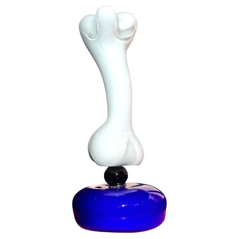 Exceptional upright murano art glass sculpture by Peter Shire in collaboration with Vistosi Murano. Signed at bottom. Most likely one of kind. Upright bone floats above a cobalt blue orb base. Stunning, timeless work with signature postmodern humor