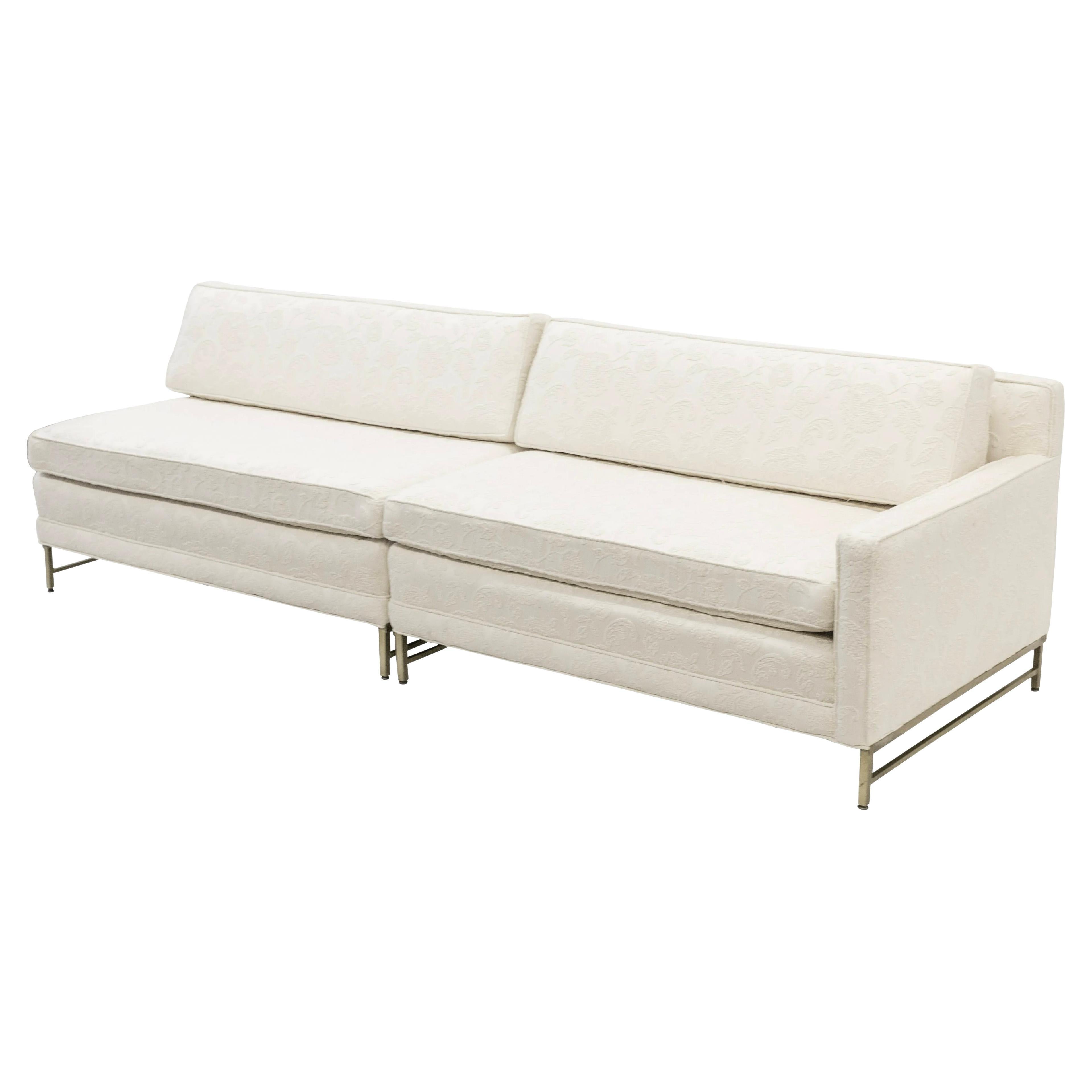 Paul McCobb for Directional, two piece sectional sofa, c 1958. Cream on cream minimal Jacobean floral textile and solid brass. Two parts can be used together as one long sofa or as separate pieces. Gorgeous lines and minimal modern design. Single