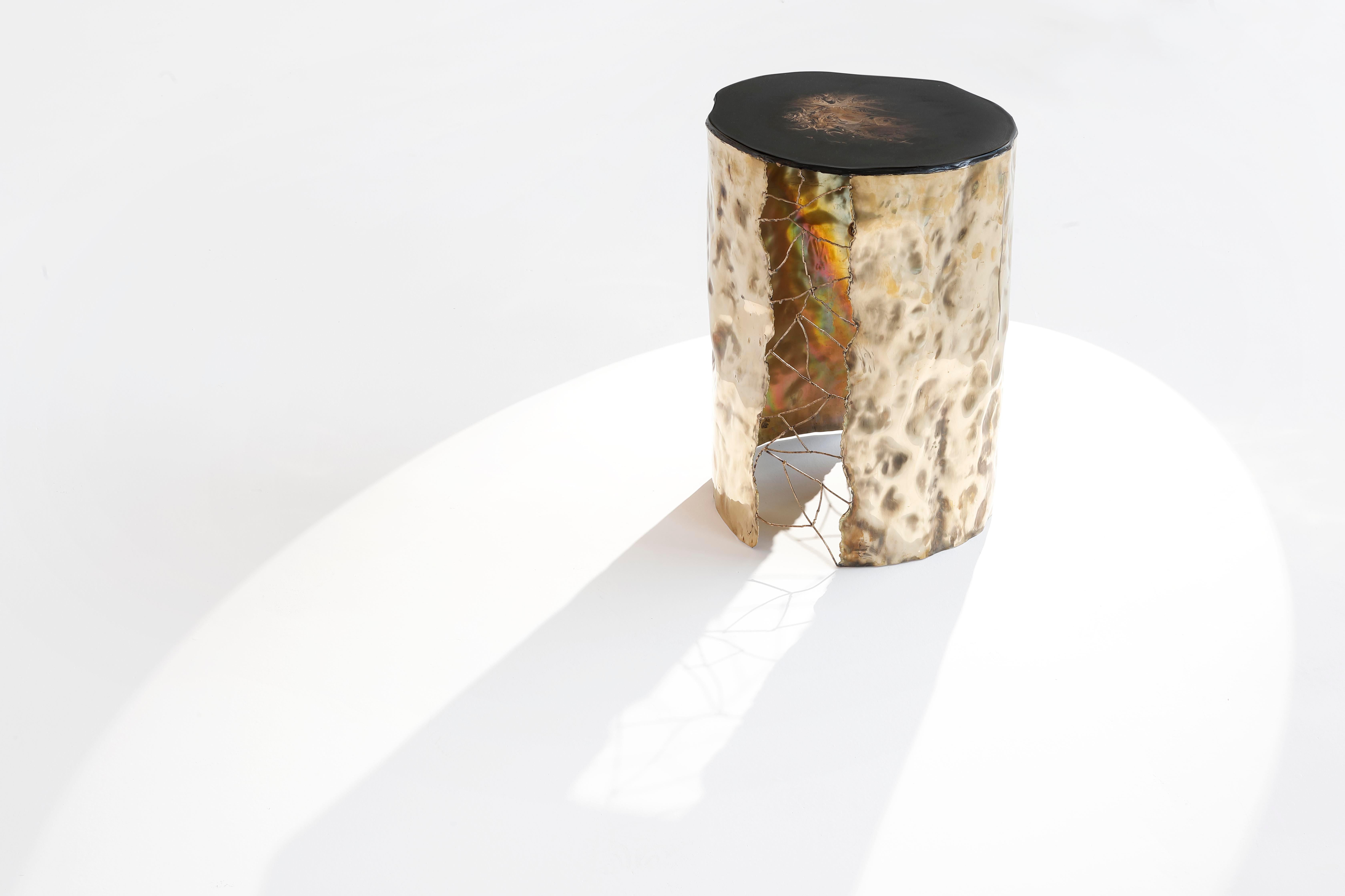 Modern side table realized in hammered brass for the structure and resin with brass dust for the top. Entirely crafted by hands in Italy, signed and numbered.
The power of fire, the connections between the elements, new and ancient techniques
