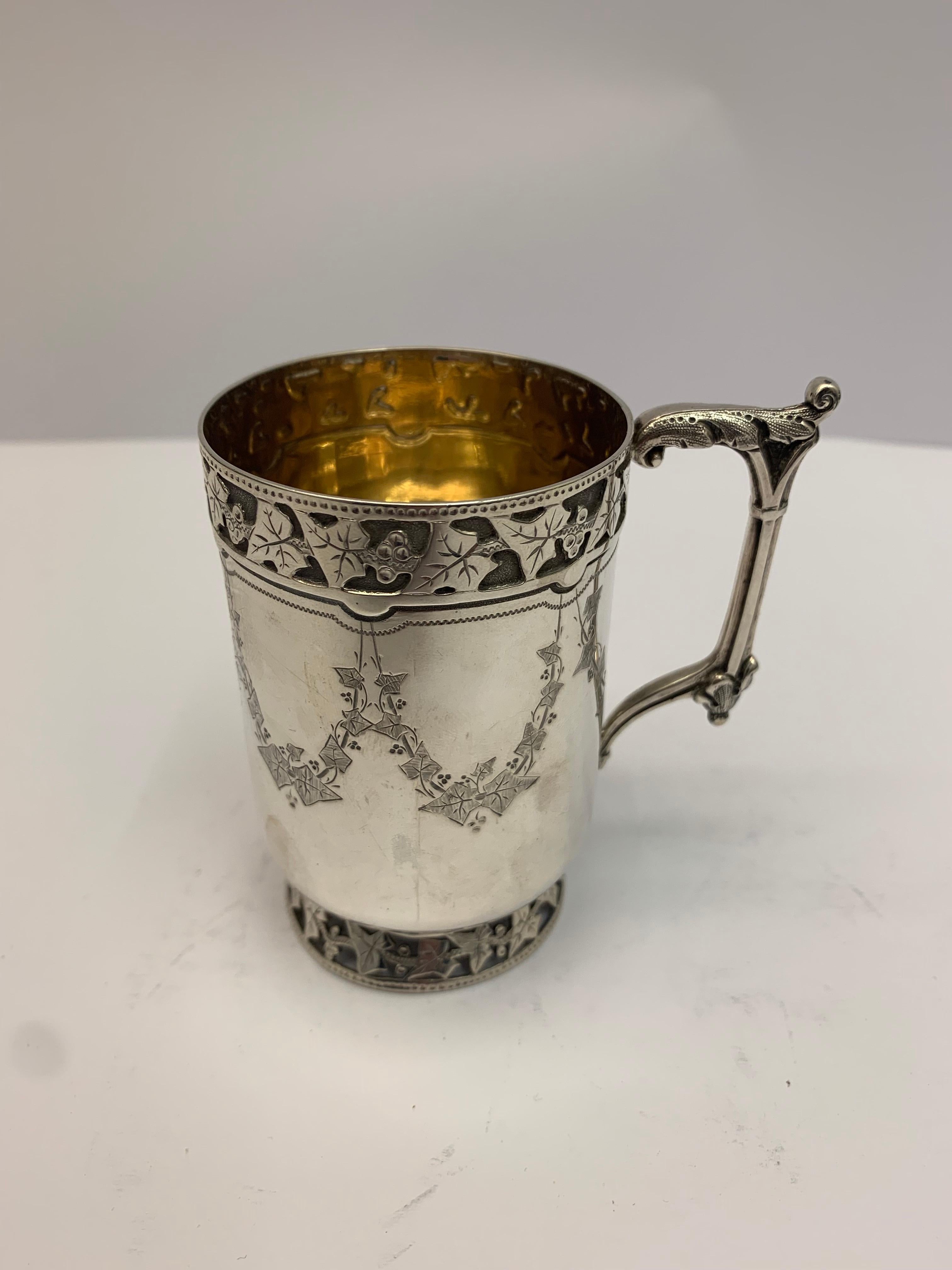 Small antique silver mug decorated with vines and leaves made by Martin Hall and Co in London.

131 grams.