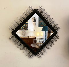 Miroir noir en métal Chaty Vallauris des années 1950 avec finition Arabesque