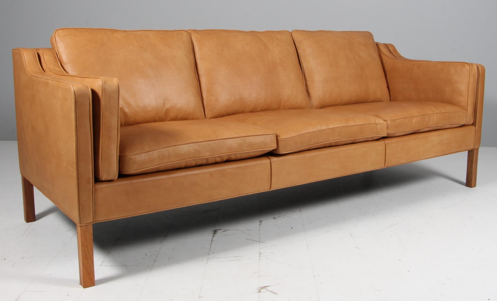 Børge Mogensen three-seat sofa new upholstered with vintage full grain aniline leather.

Legs of nut.

Model 2213, made by Fredericia Furniture.
