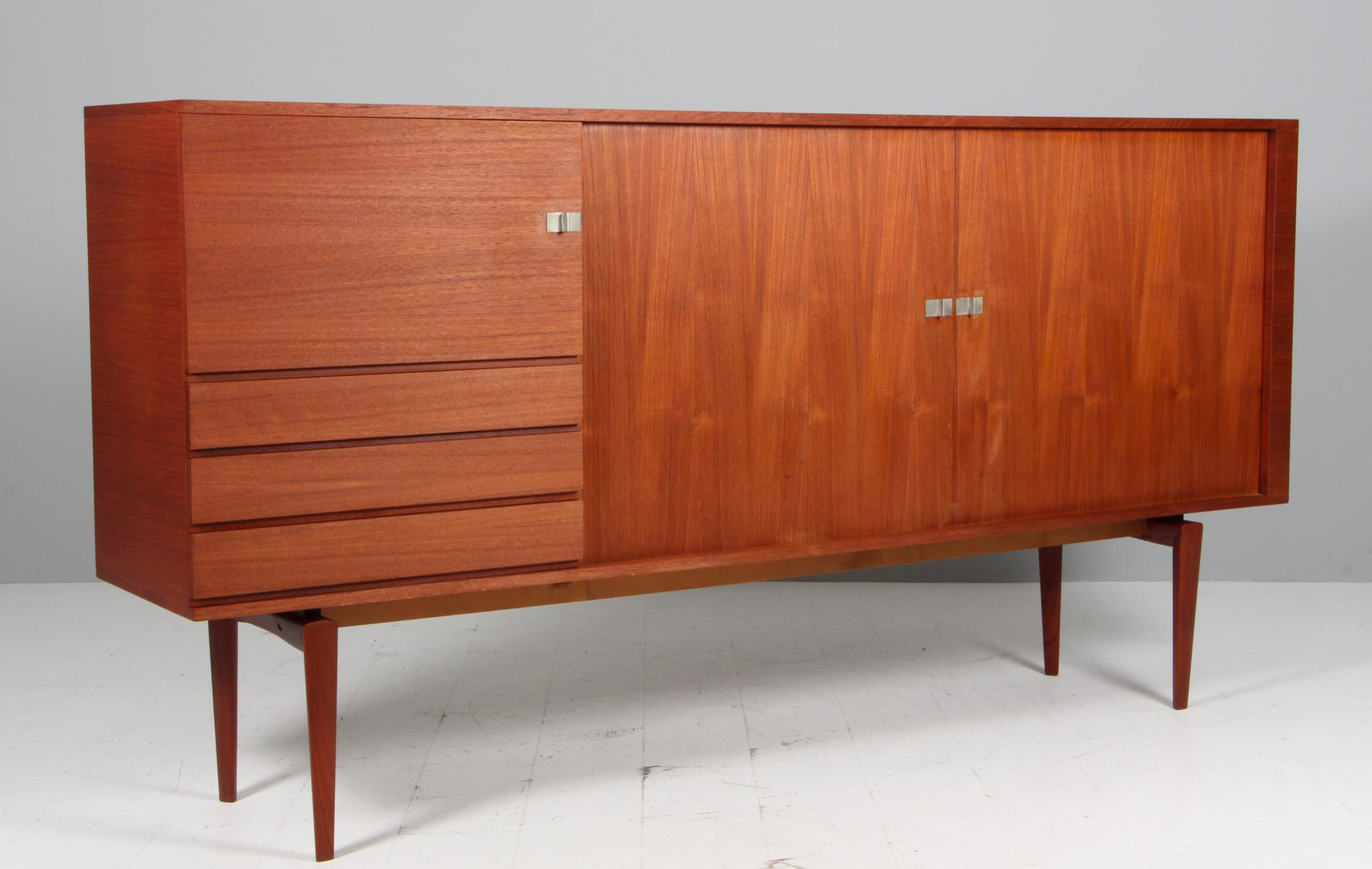 Danish Cabinetmaker sideboard in teak. Sliding doors, drawers and doors.

Made in the 1960s