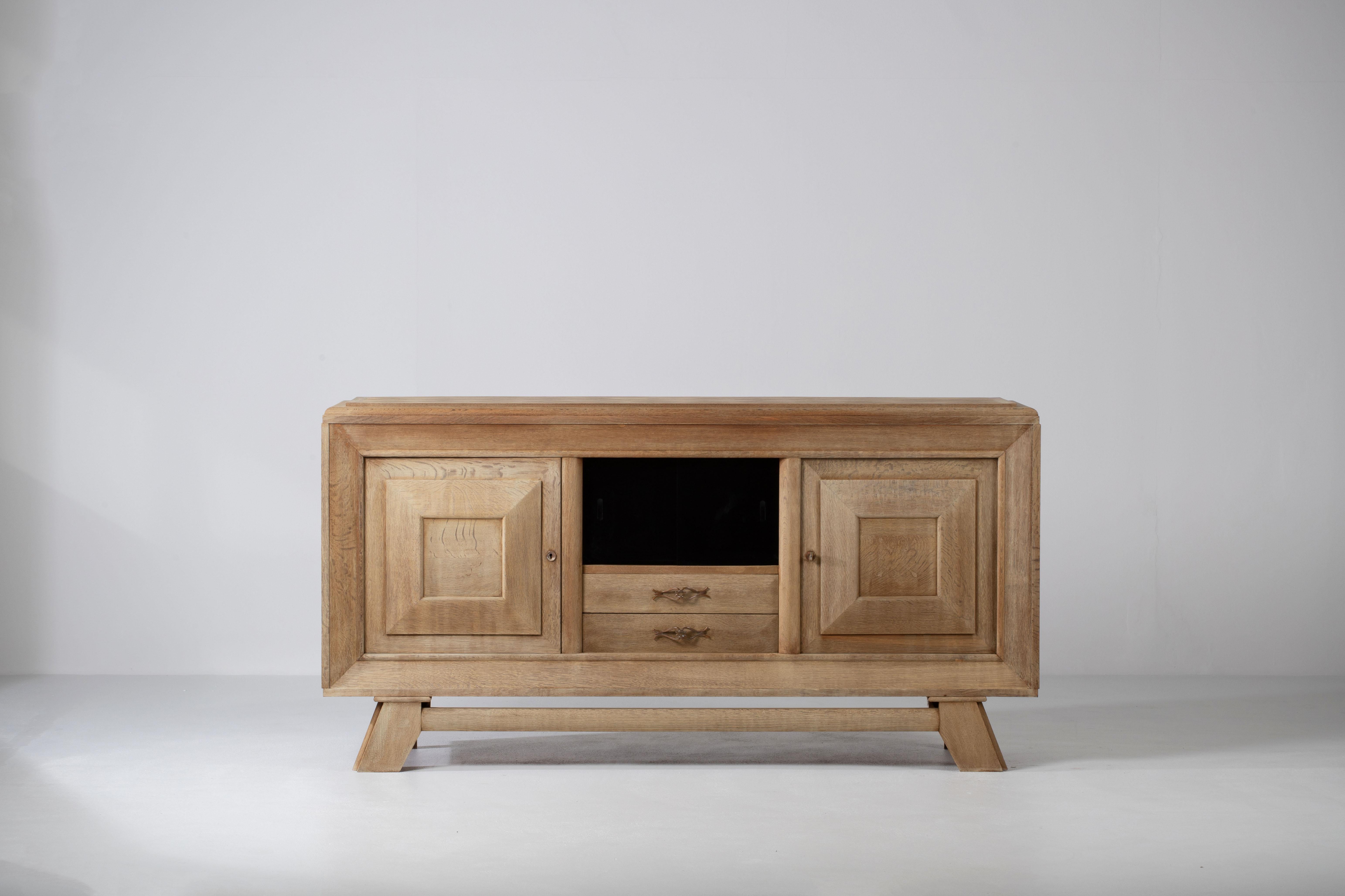 French Art Deco Bleached Oak Sideboard After Charles Dudouyt, 1940s

A composition of quiet authority, this French sideboard reveals a language of sculptural clarity and disciplined geometry. Attributed to the workshop of Charles Dudouyt, the piece
