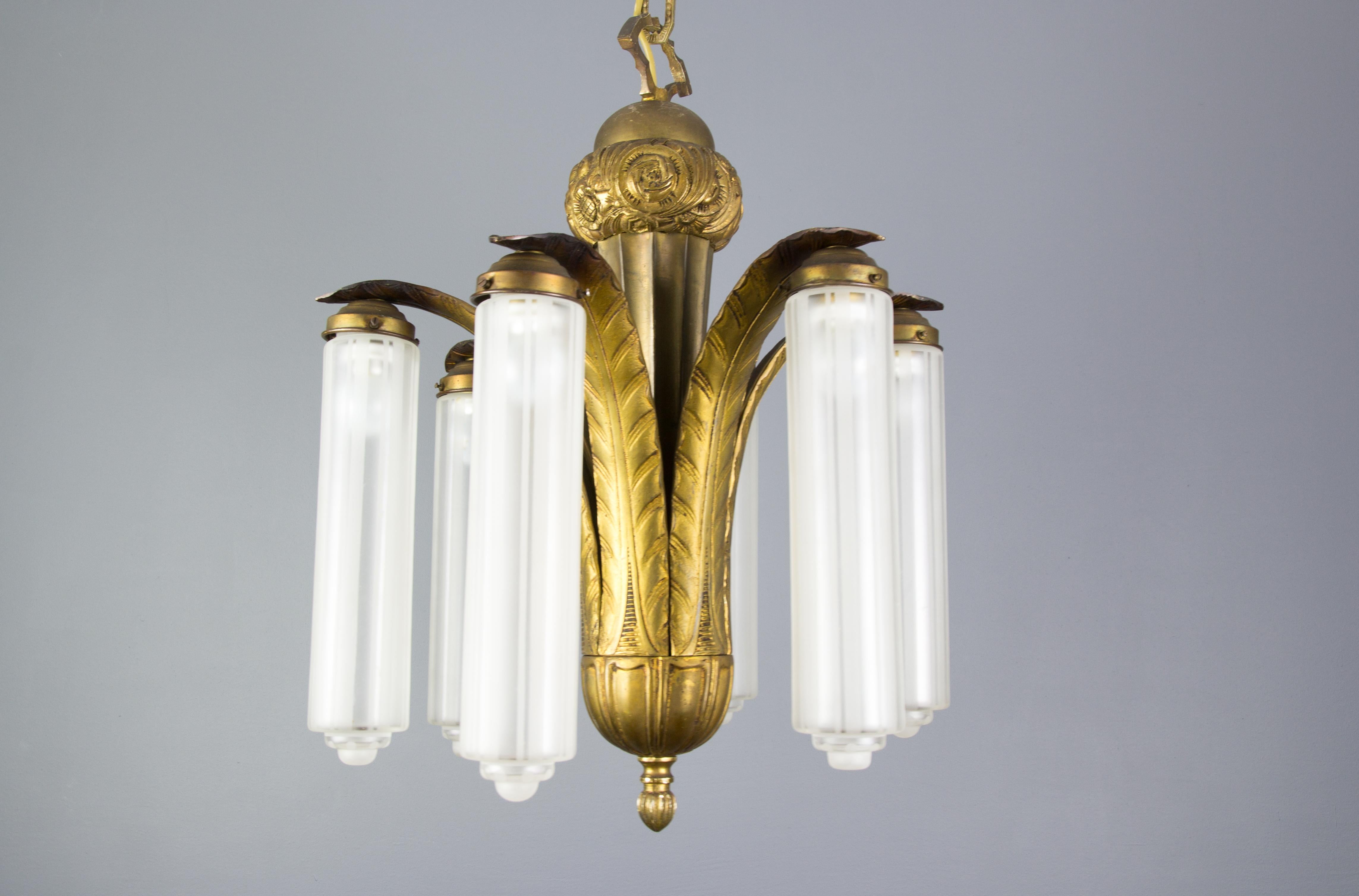 Imposing French Art Deco bronze chandelier from the 1920s. Six bronze arms with six striped
frosted glass lamp shades. Each arm has an original E27 socket with new wiring. 
Free delivery in Germany.
Measures: Total height is 33.5 inches / 85 cm,