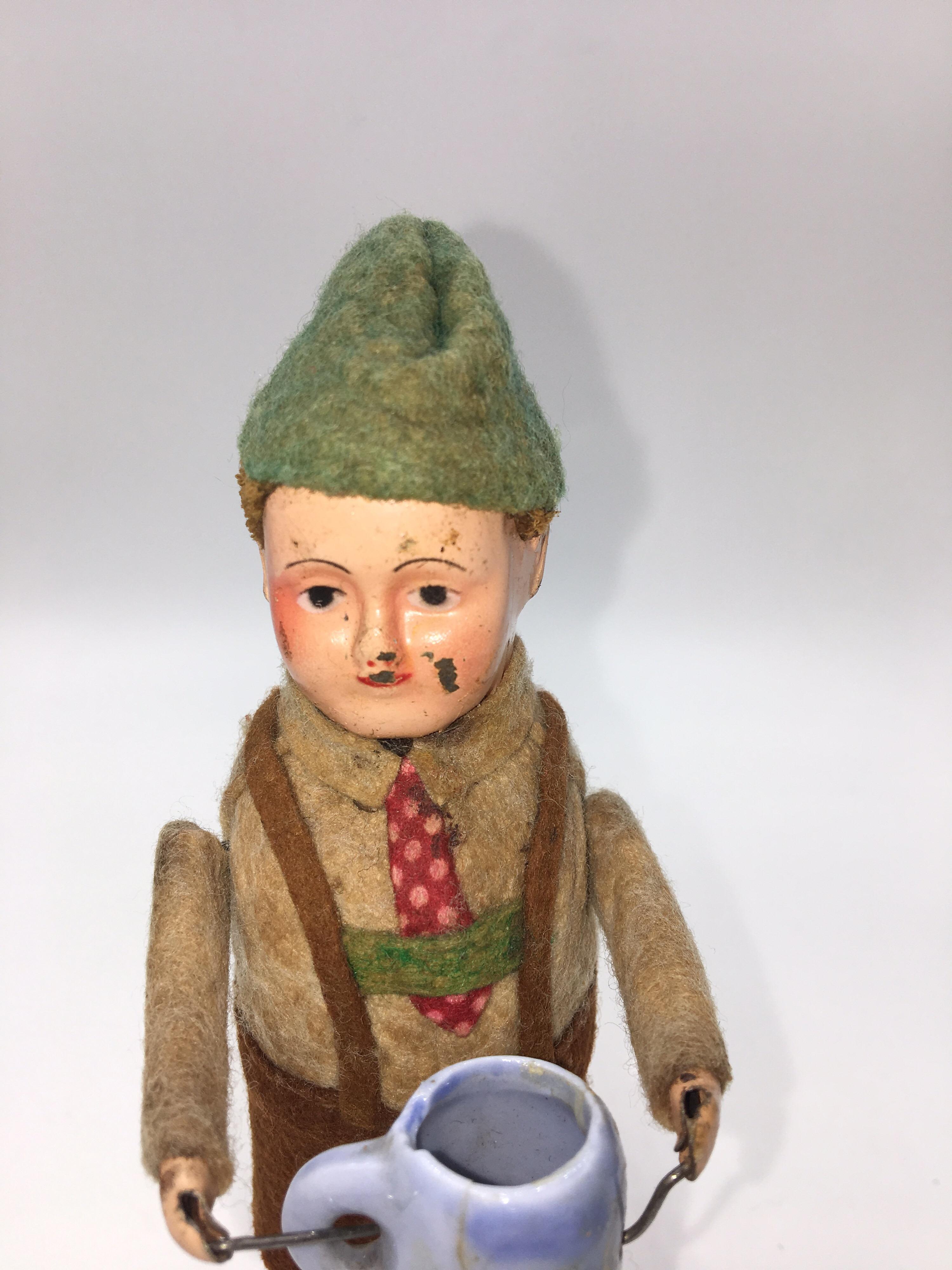 Schuco tin wind up young man drinking from German bisque stein, circa 1930
Made in Germany, pre-war period.
