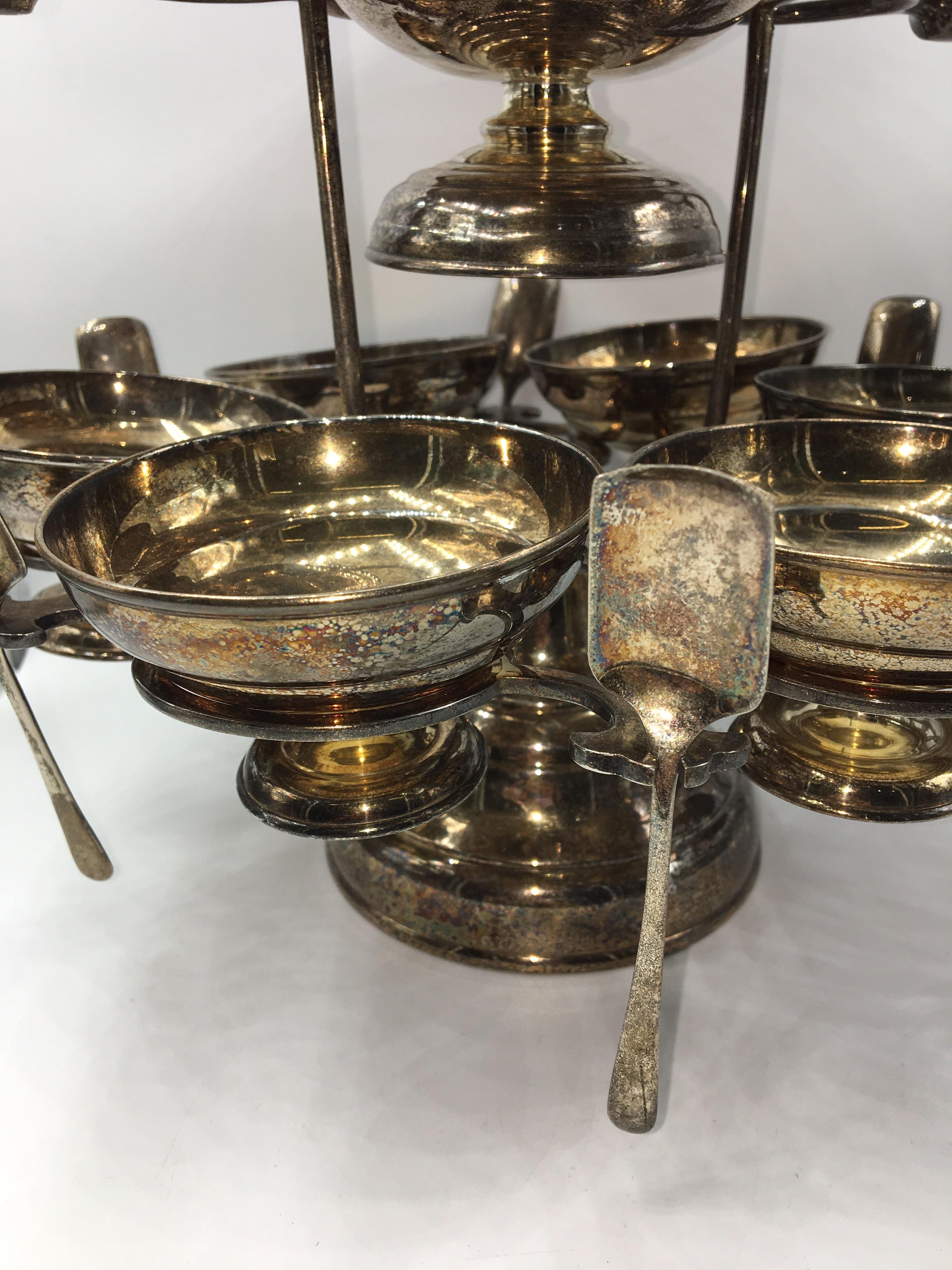 Beautiful and particular caviar serving set with large cup and 6 small each cin cin own spoon.
Silver plated set.