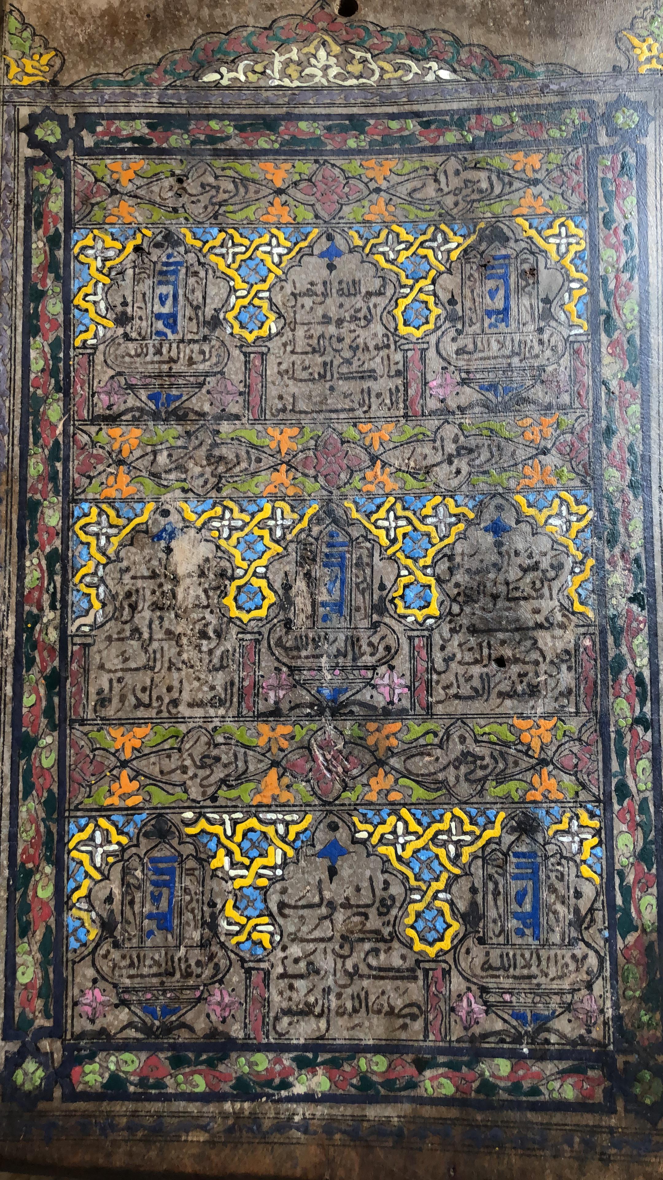 Vintage hand painted hardwood tablet inscribed with the opening verse from the Holy Quran, Bismillah hir-Rahman nir-Rahim. This tablet is circa early to mid-20th century and is from the southern Moroccan desert town of Zagora. Used in schools to