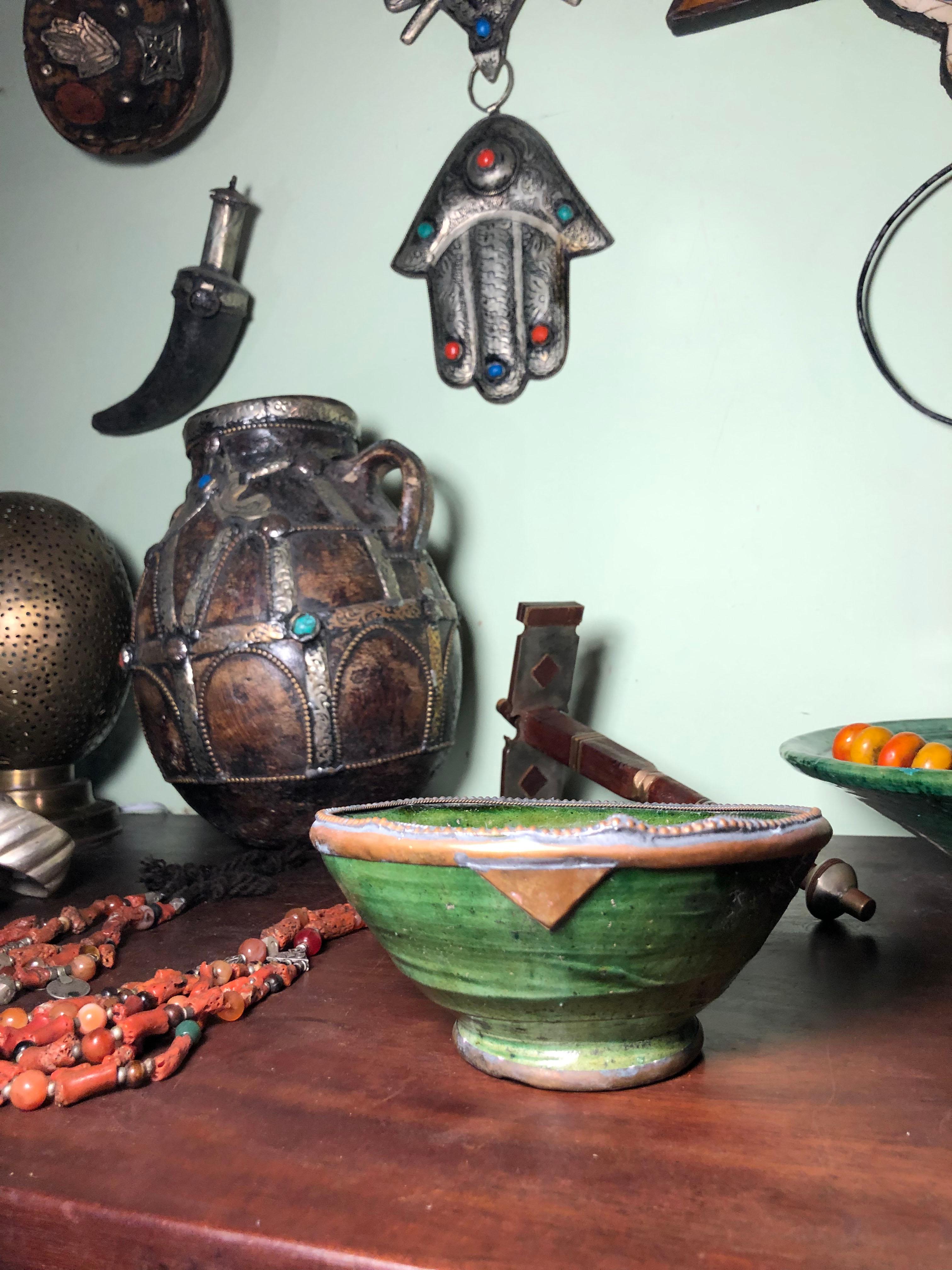 This Moroccan green pottery bowl was handmade in Tamegroute, a small village in the Draa Valley of southern Morocco. The spectacular green pottery gets its color from naturally occurring copper in the clay from the Draa River and a magnesium-based