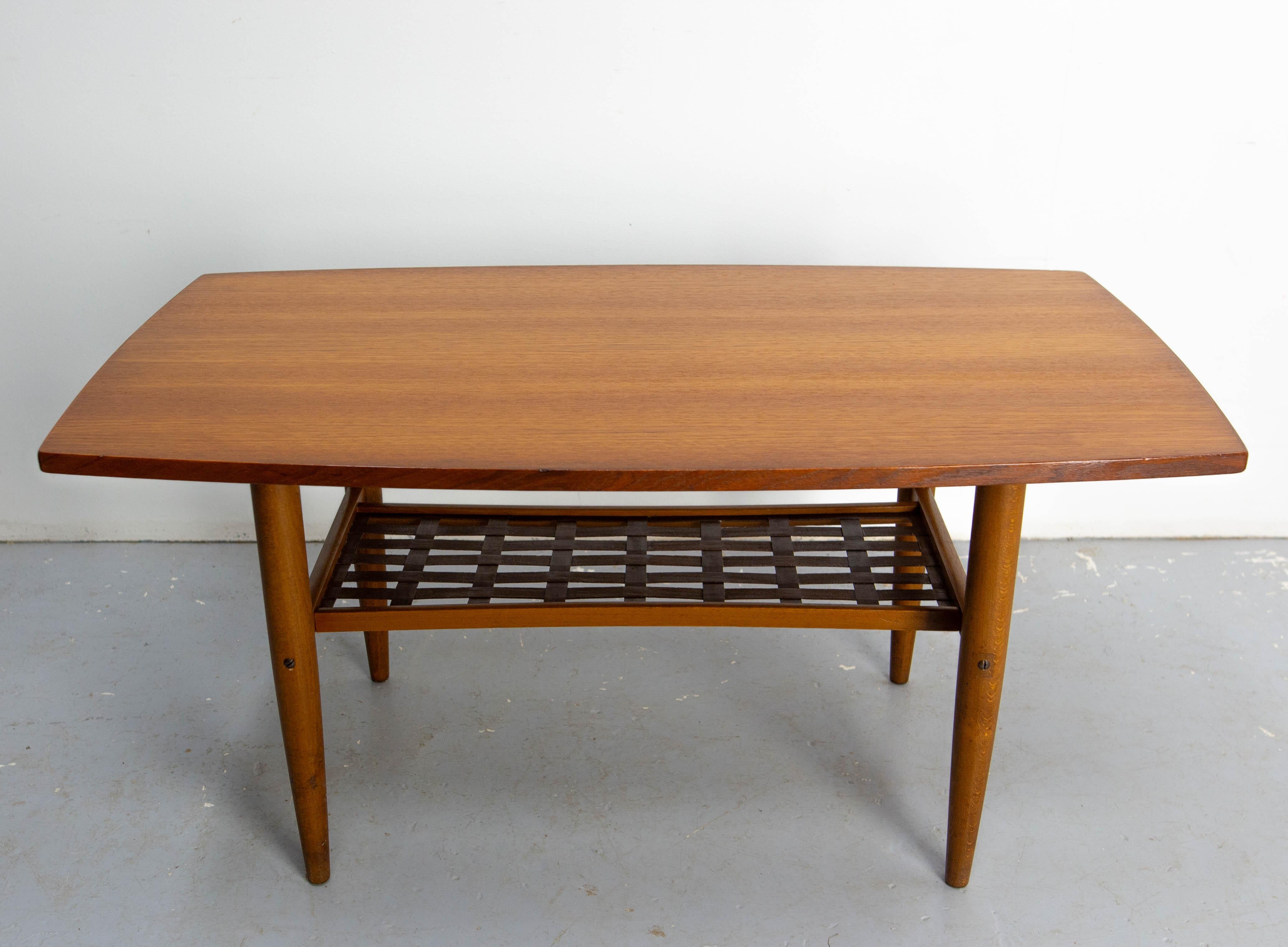 Teak coffee table produced in Sweden in the 1960s. 
By Albert Larsson for Alberts Tibro.
Simple and sleek, this table will fit perfectly in a small living room. Beech wood base and magazine rack. Excellent condition and very stable with minimal
