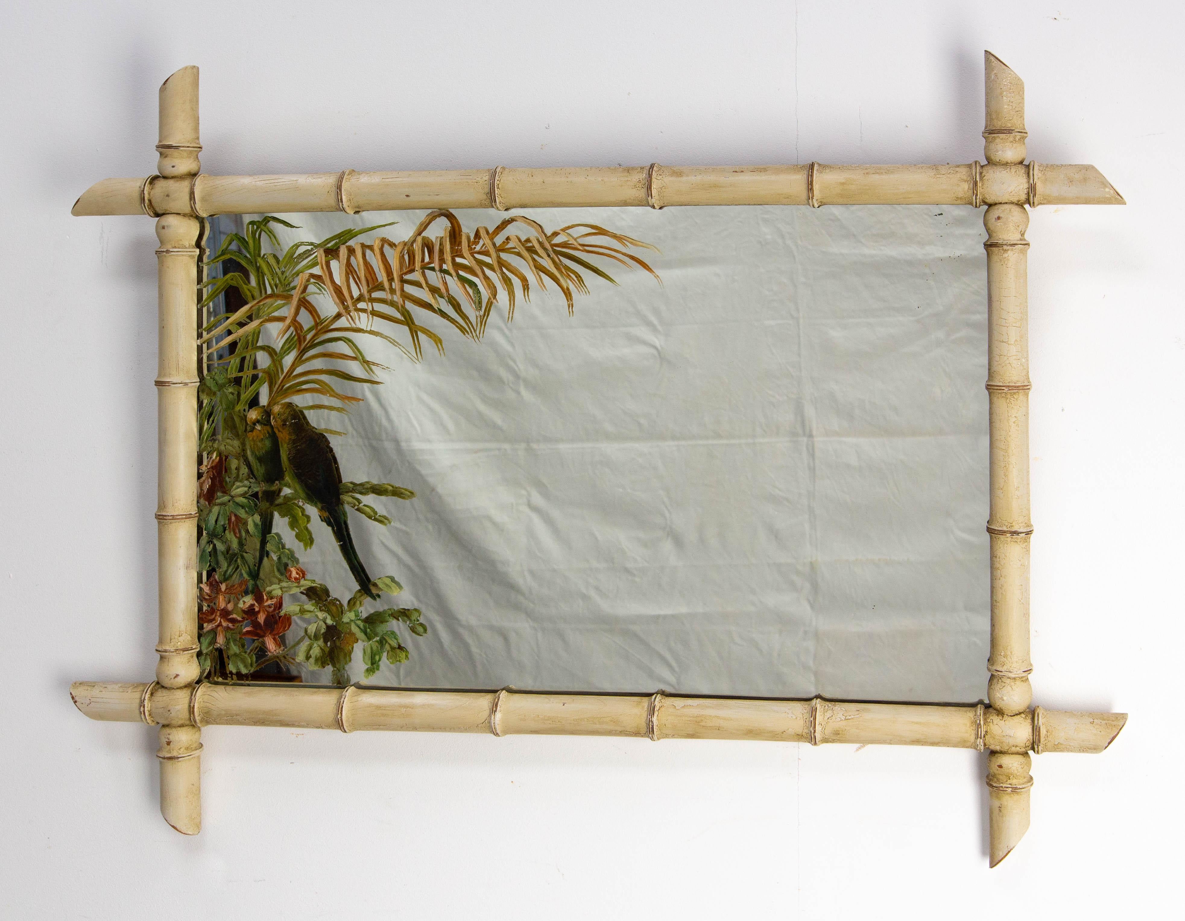 French rectangular wall mirror in faux bamboo wood.
The frame has be re-painted and re-patinated by our cabinetmaker.
The mirror painting has been made circa 1910 too.
The painting depicts a pair of parakeets in a setting of exotic vegetation (palm
