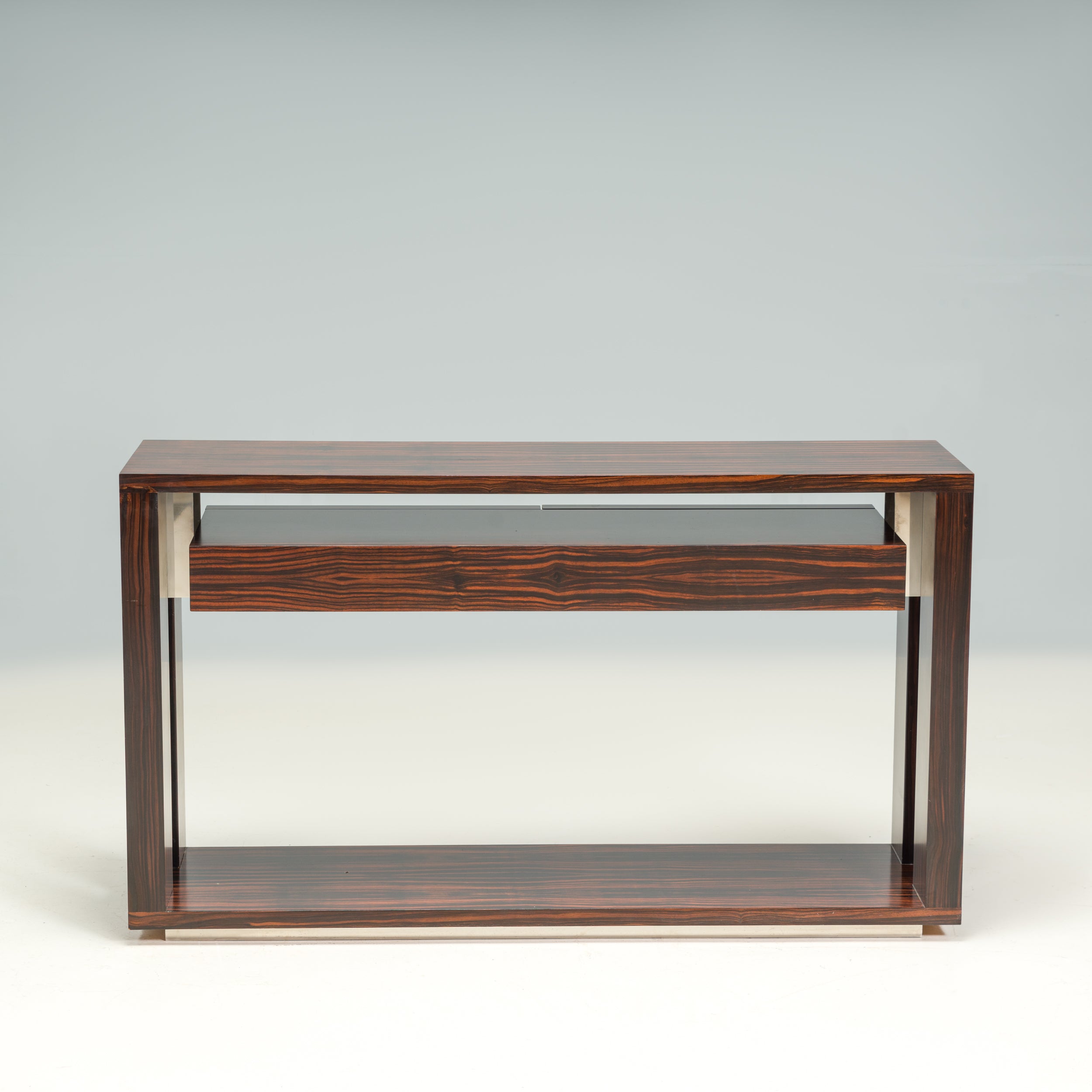 Designed and manufactured by B&B Italia, this Eucalipto console table is a fantastic example of contemporary Italian design.

Constructed from wood with a glossy frisé eucalyptus veneer finish, the console table has an angular silhouette, with four