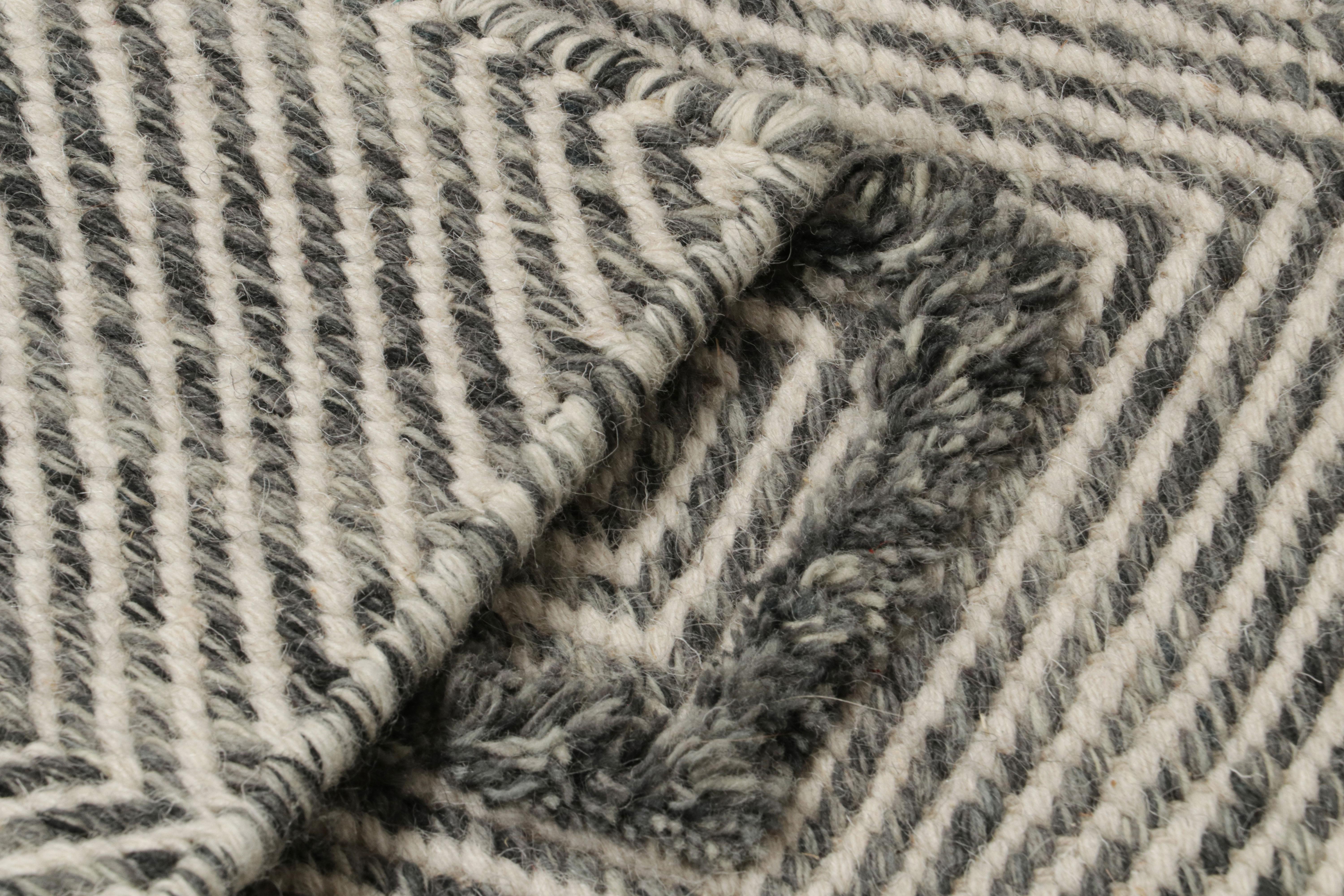 Handwoven in wool, a 2x2 scatter rug from Rug & Kilim’s modern selections.

On the Design:

The piece plays flatweave and pile together as seen in the larger diamond patterns which sport a shaggy, high-pile texture that stands out from the flatweave