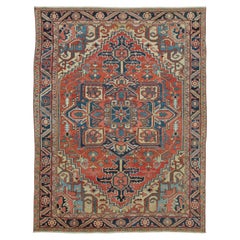 Alfombra persa antigua de Heriz con medallón geométrico en rojo y azul - Rug & Kilim