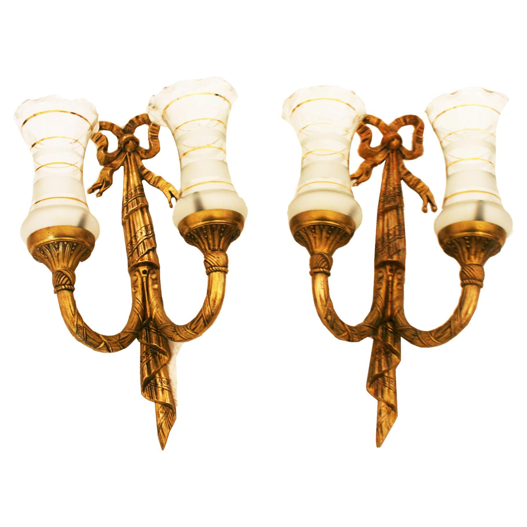 The price for the lot

Pair of midcentury brass wall sconces Louis XVI style 
 with two lights.

Brass and gold trimmed glass.

Bathroom fixtures, bathroom lights.

