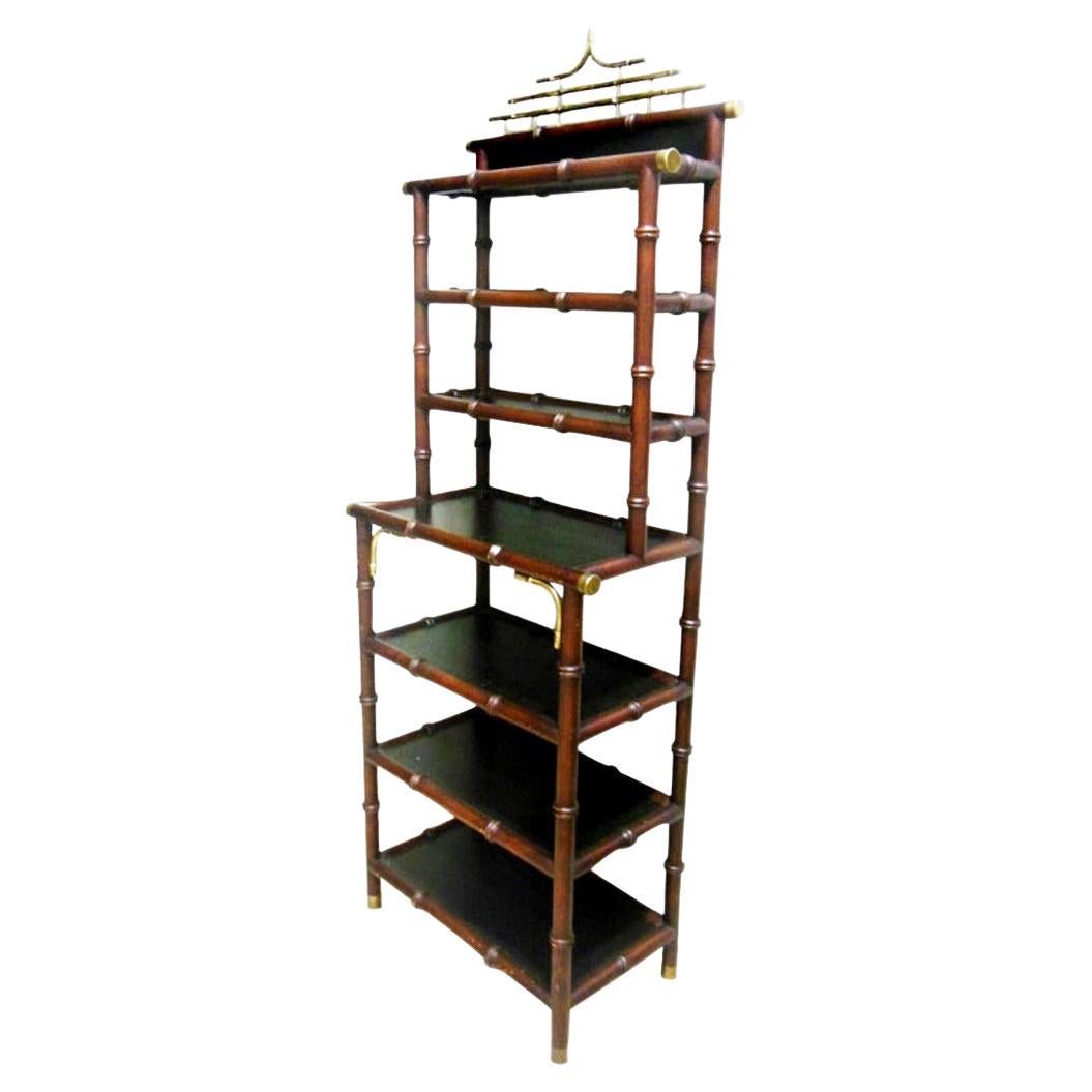 Hollywood Regency  style shelves features pagoda form, 1950s

Has 4 shelves in the lower parade and 3 in the narrower upper one

Made of fine wood in the shape of faux bamboo and brass on the links and the upper part of the pagoda 

 