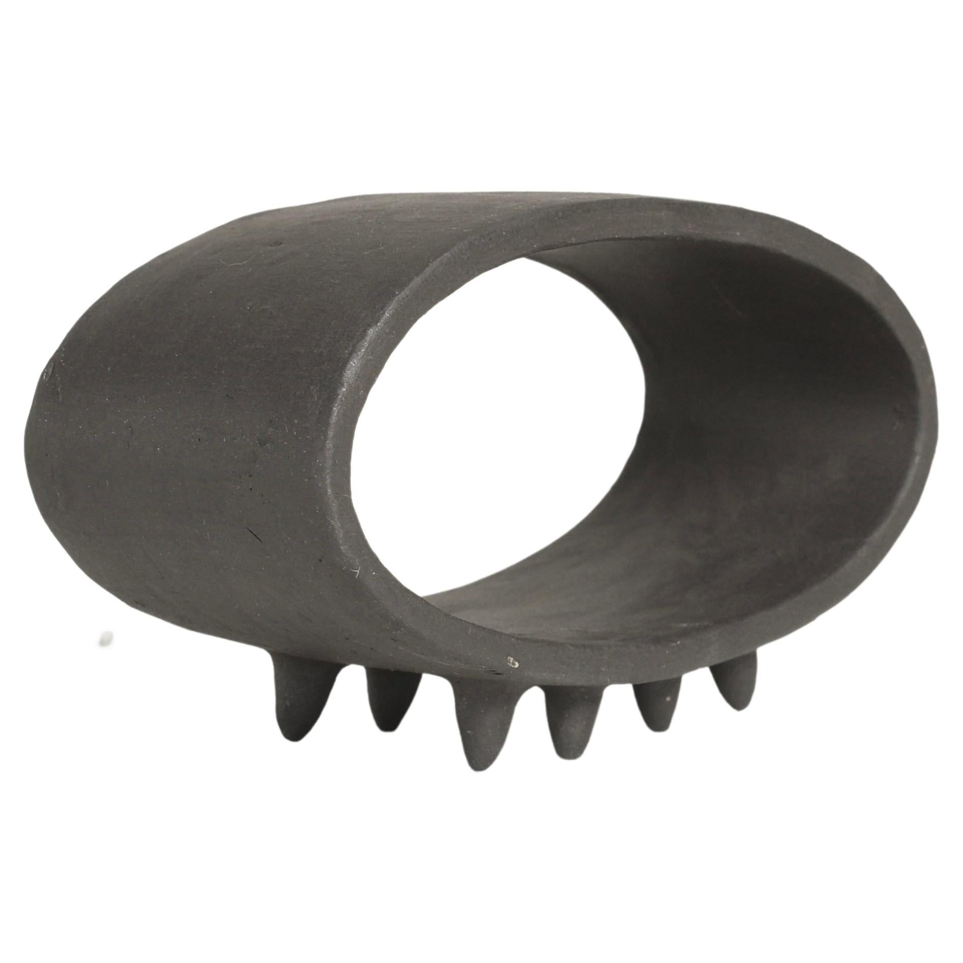 Black Oval Ceramic Sculpture with 2 Rows of Small Pointed Feet