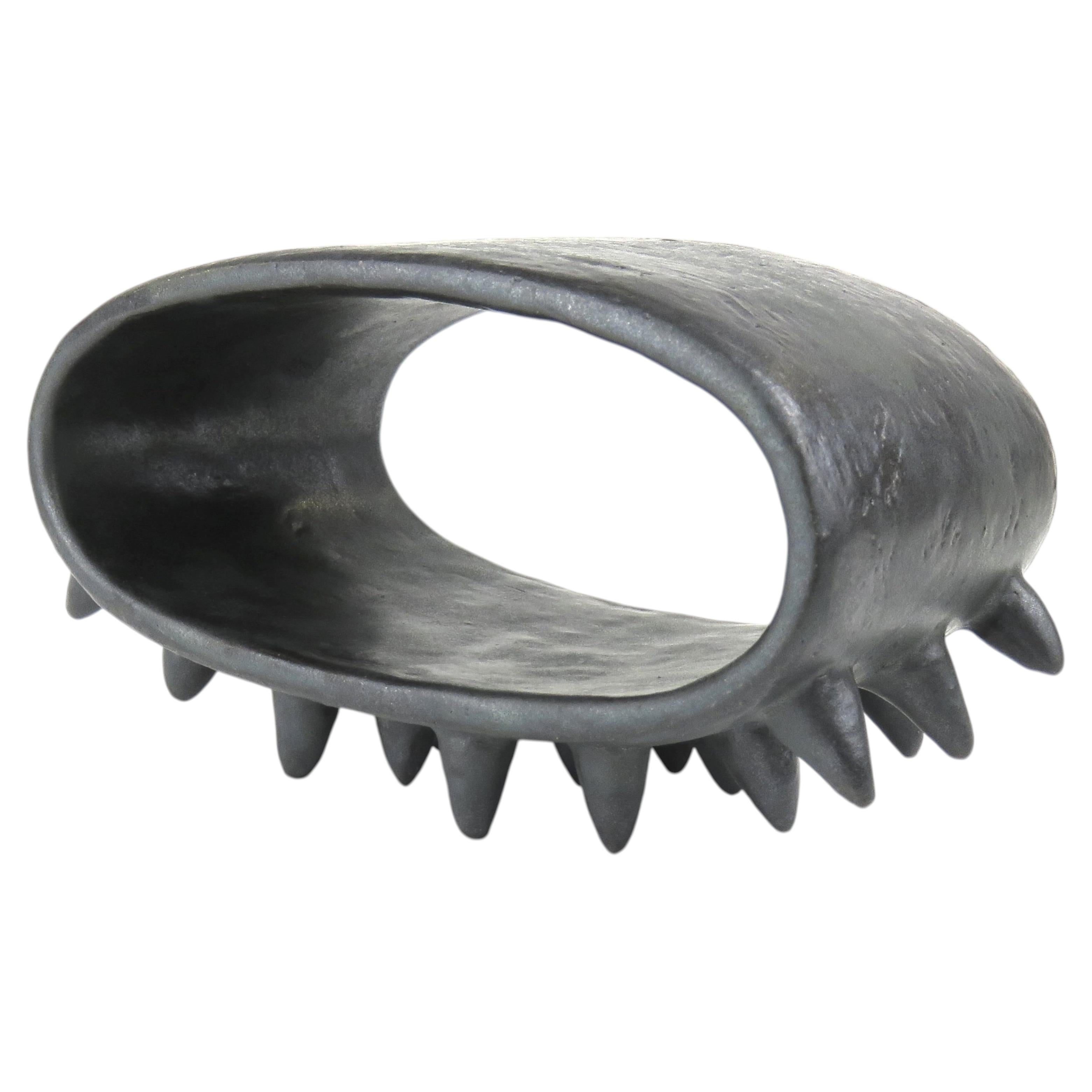 Black Oval Ceramic Sculpture With Many Small Spike Feet